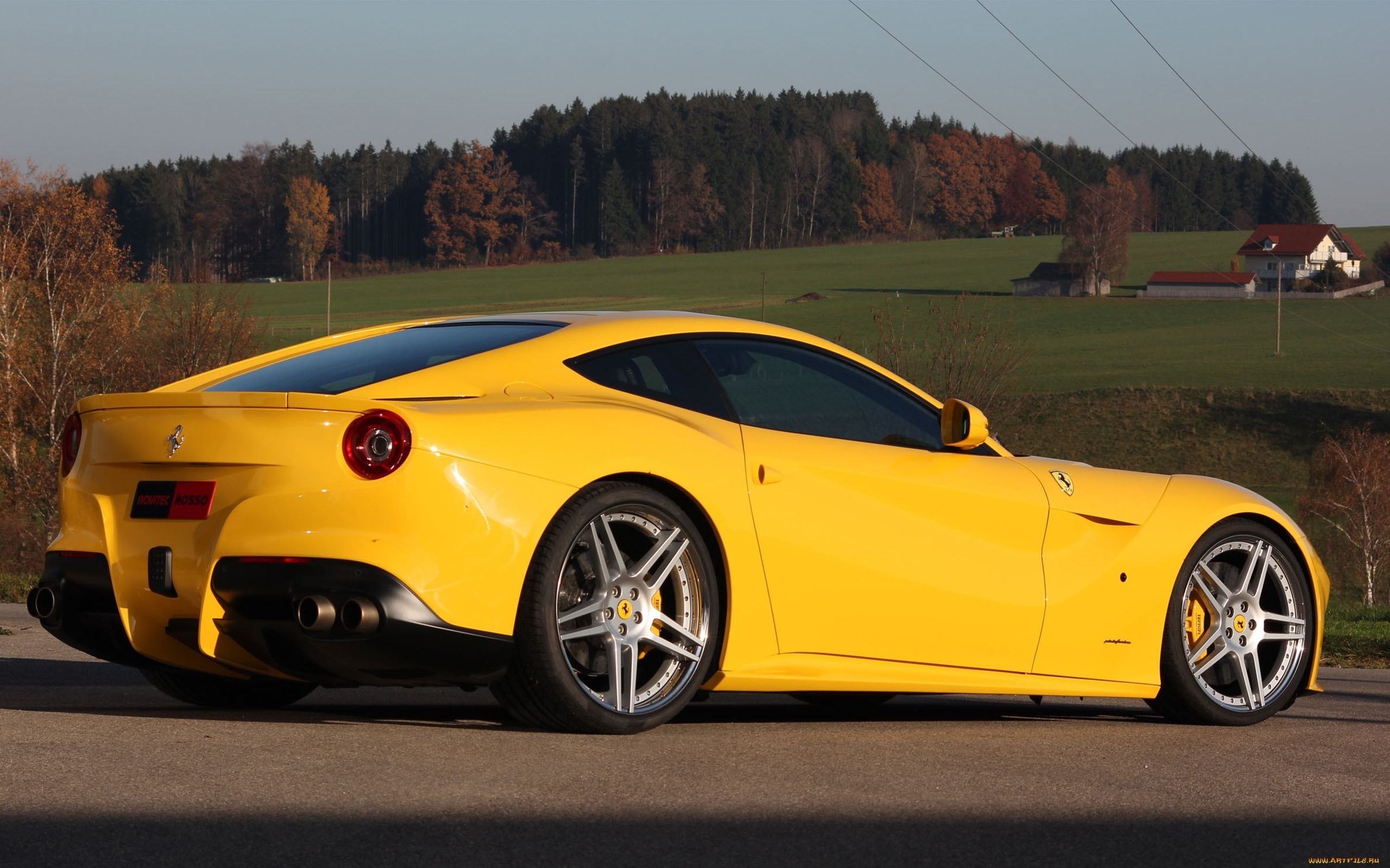 Yellow Ferrari F12berlinetta parked on a road HD Wallpaper