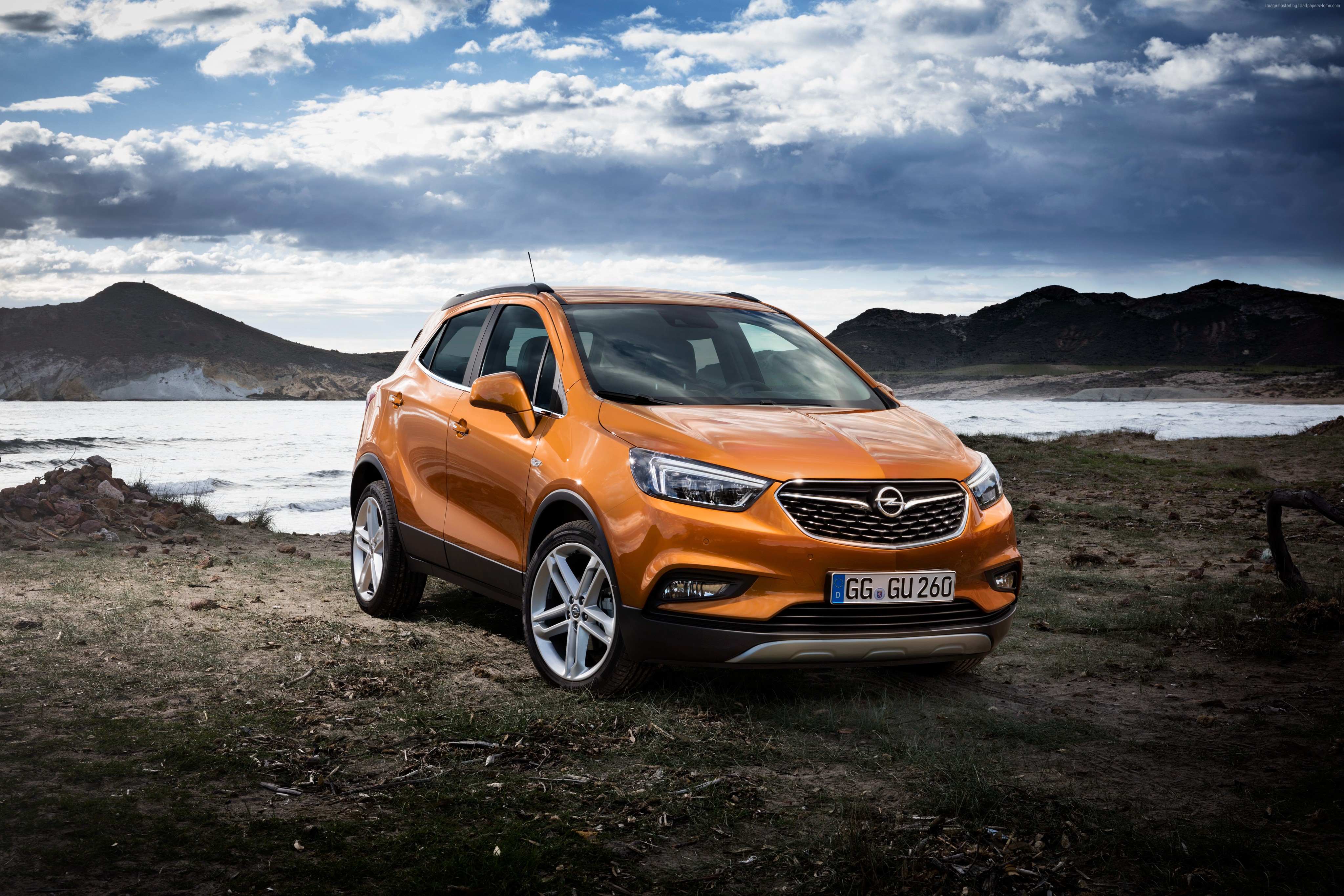 Orange Opel Mokka X SUV on a rocky shore HD Wallpaper