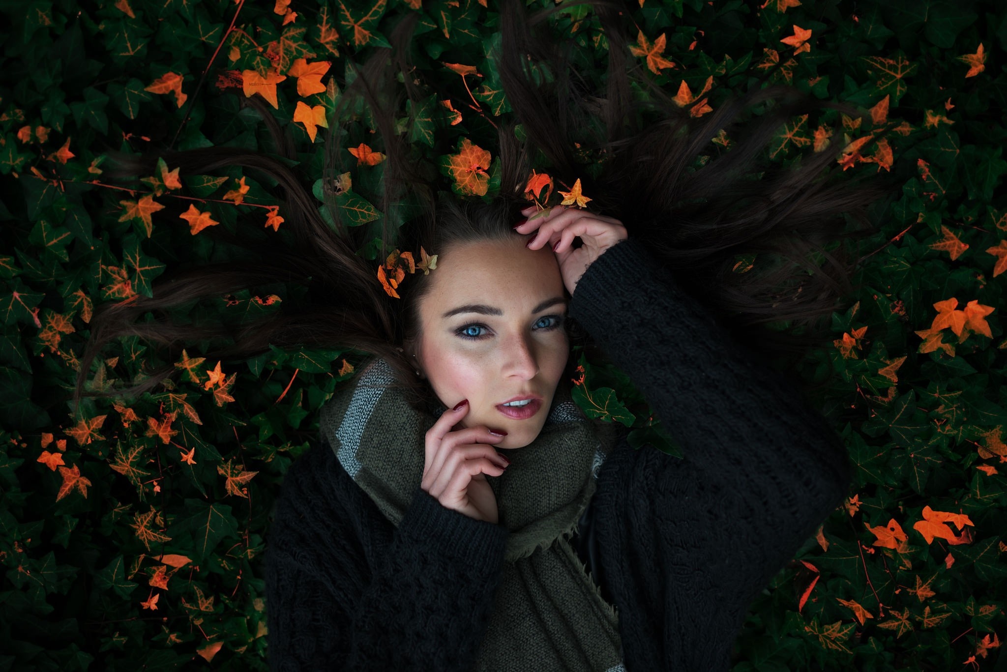 Woman lying down in autumn leaves HD Wallpaper