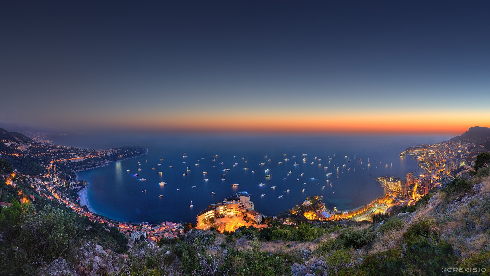Panoramic view of Monaco coastline at sunset with numerous yachts HD Wallpaper