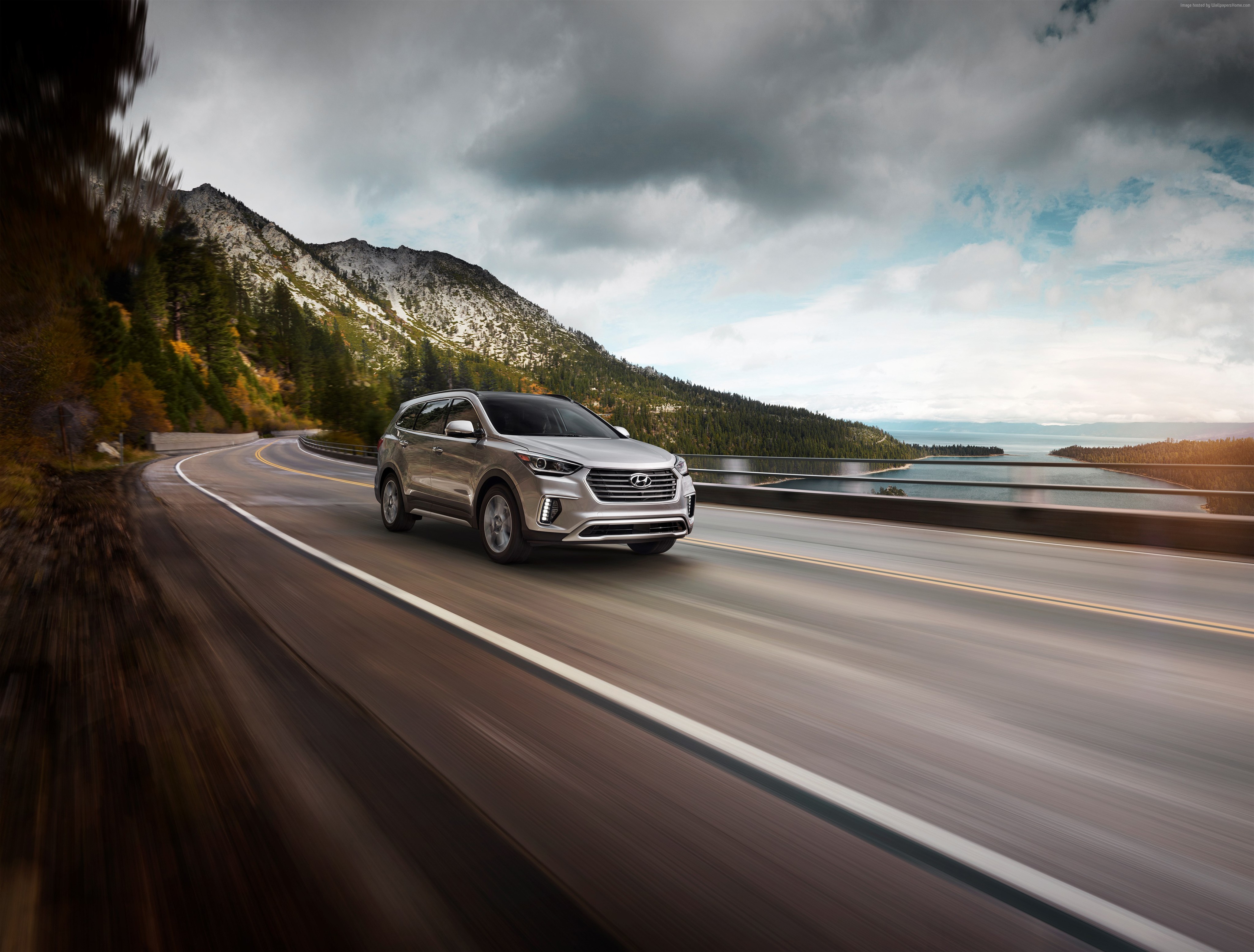 Hyundai Santa Fe driving on a scenic mountain road HD Wallpaper