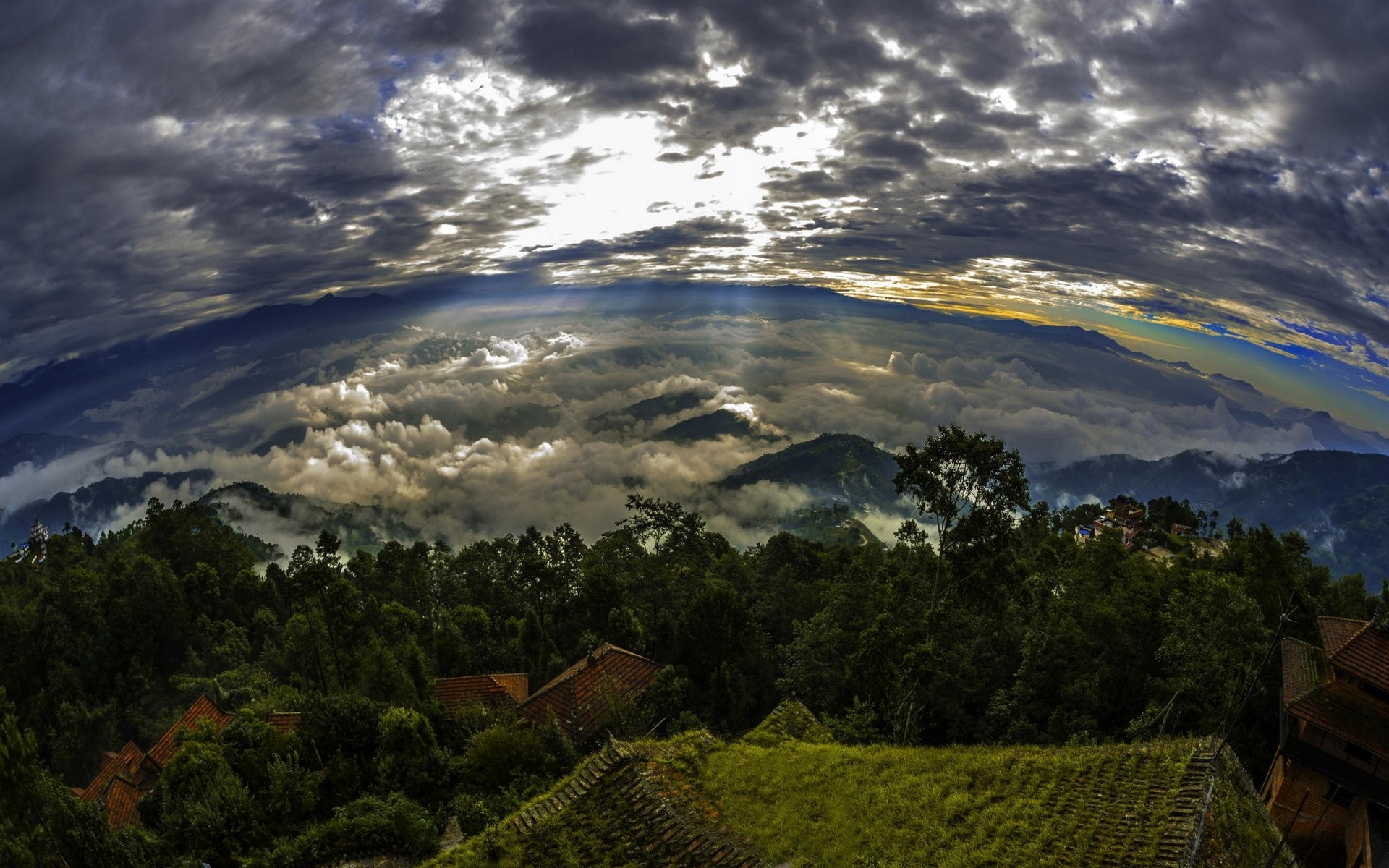 Mountain landscape with clouds and sun rays over rooftops HD Wallpaper