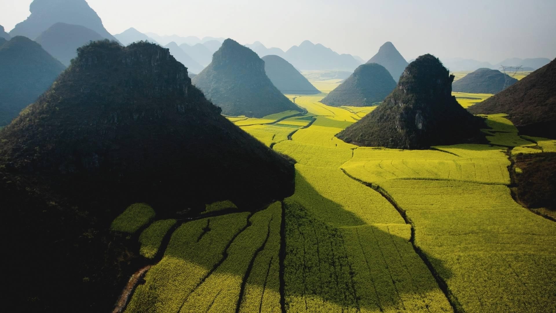 Karst mountains and yellow rapeseed fields HD Wallpaper