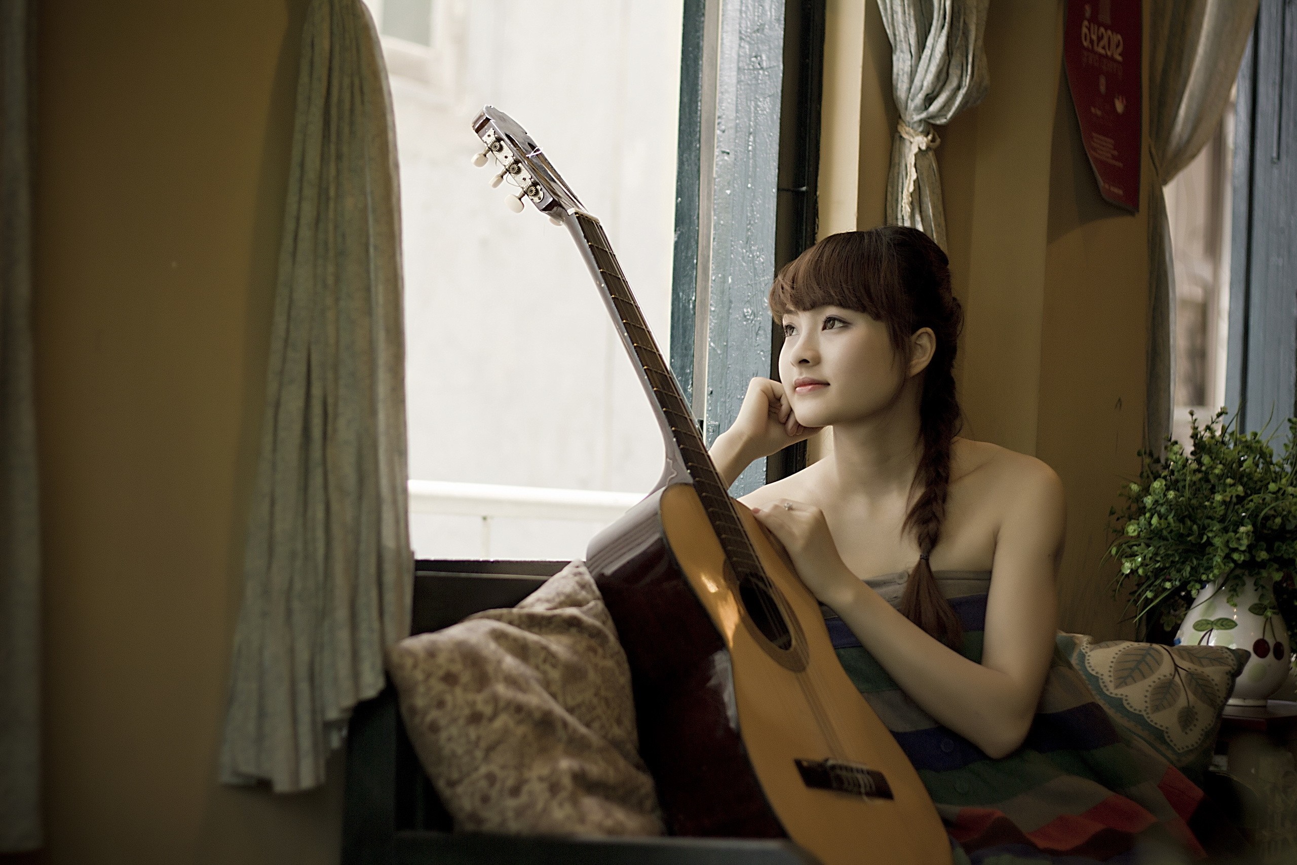 Young woman with guitar by the window HD Wallpaper
