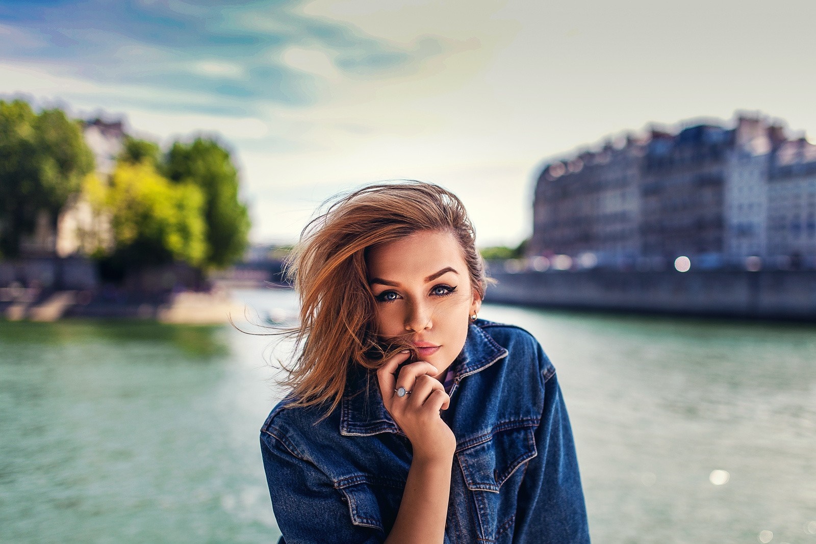 Woman in denim jacket by a river in Paris HD Wallpaper