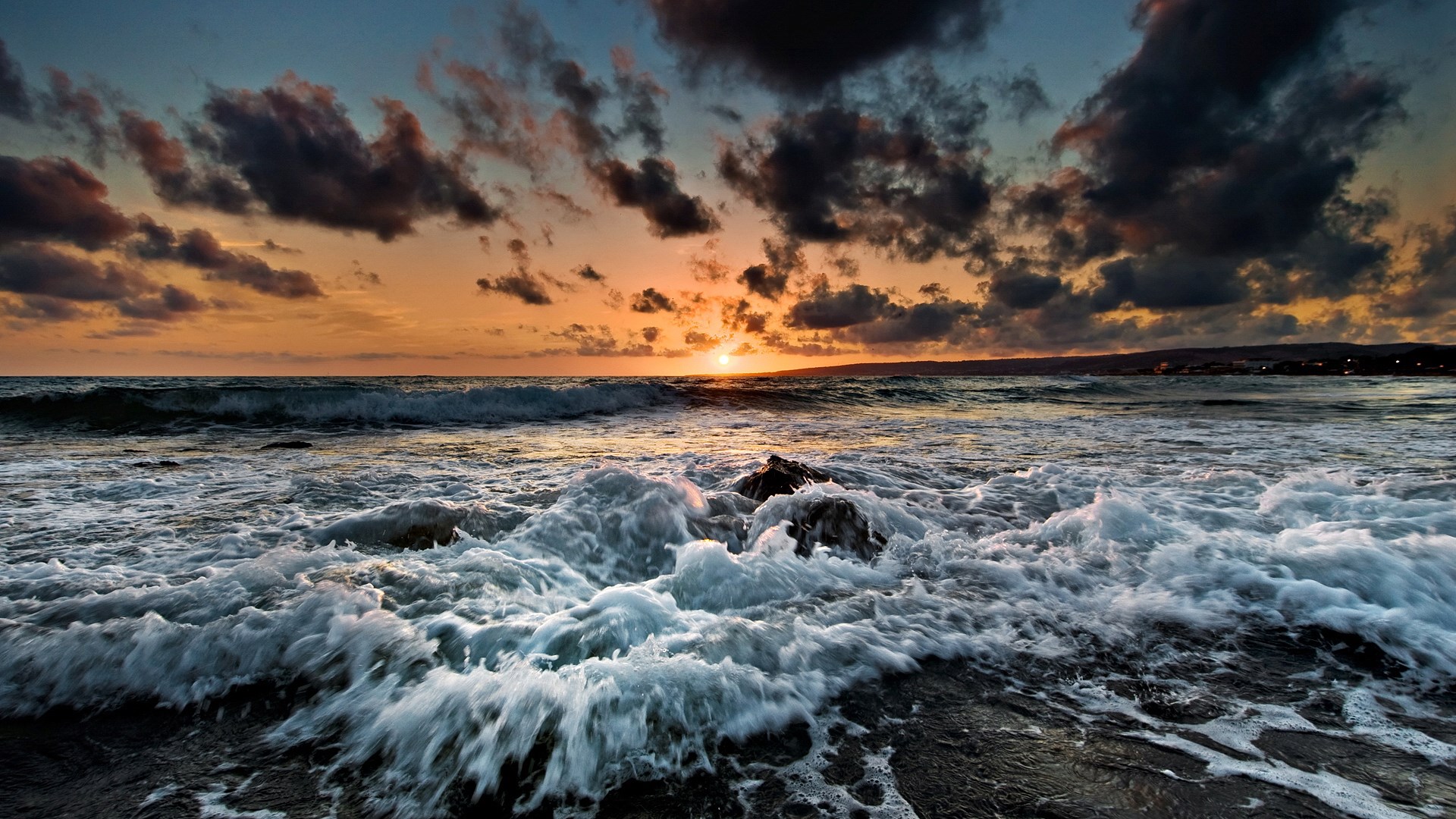 Sunset over the ocean with crashing waves HD Wallpaper