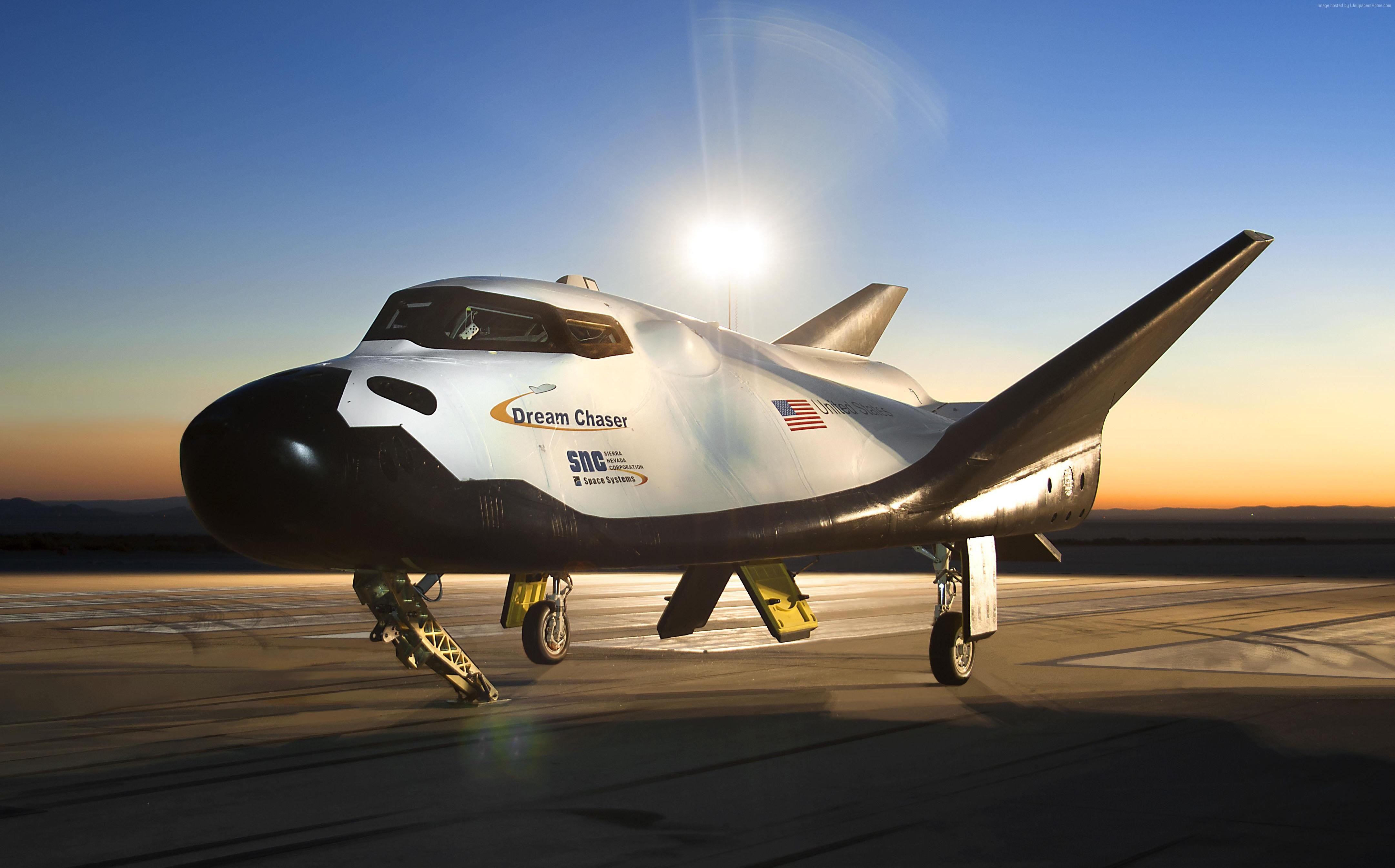 SpaceDev Dream Chaser spaceship on tarmac at sunset HD Wallpaper