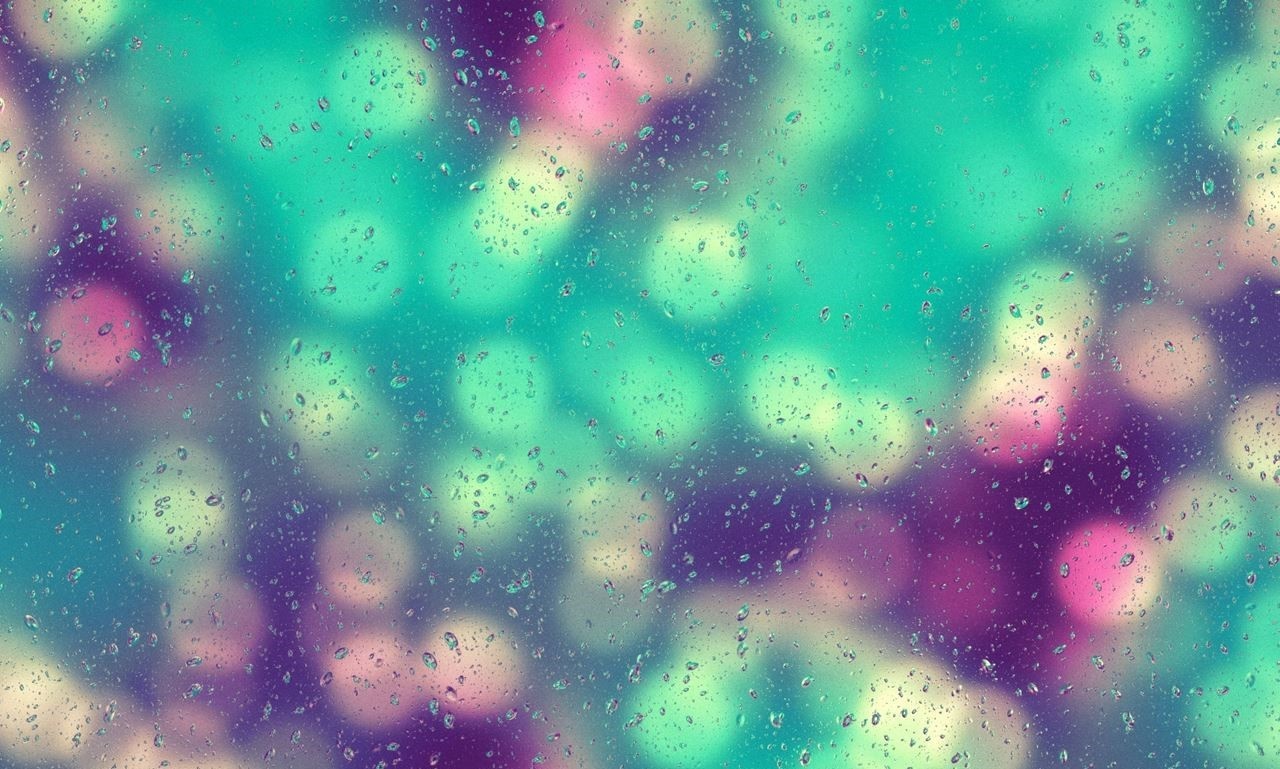 Raindrops on glass with colorful bokeh lights HD Wallpaper