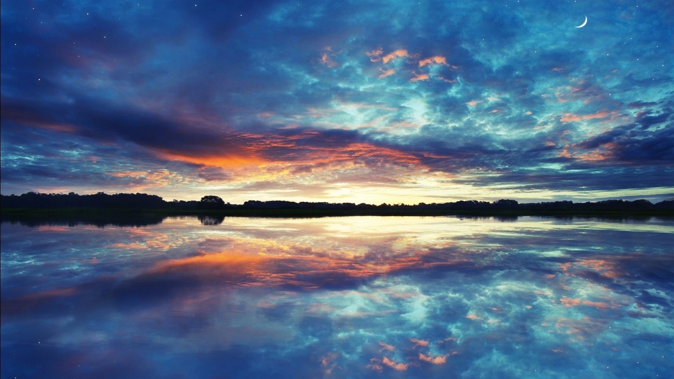 Sunset over a calm lake with colorful clouds and reflection HD Wallpaper