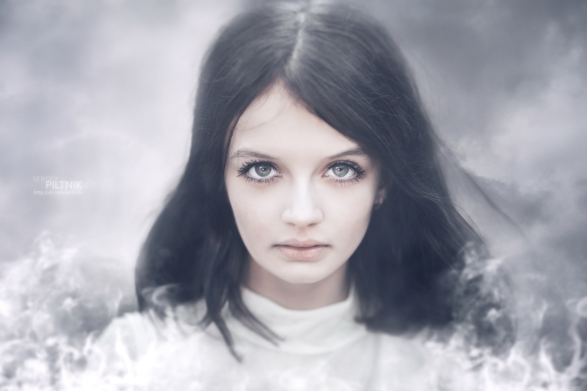 Portrait of a young woman with dark hair and striking eyes HD Wallpaper