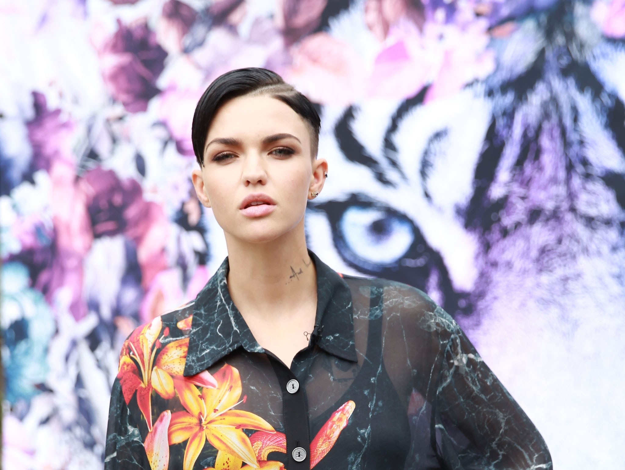 Ruby Rose posing in front of a floral and tiger print background HD Wallpaper