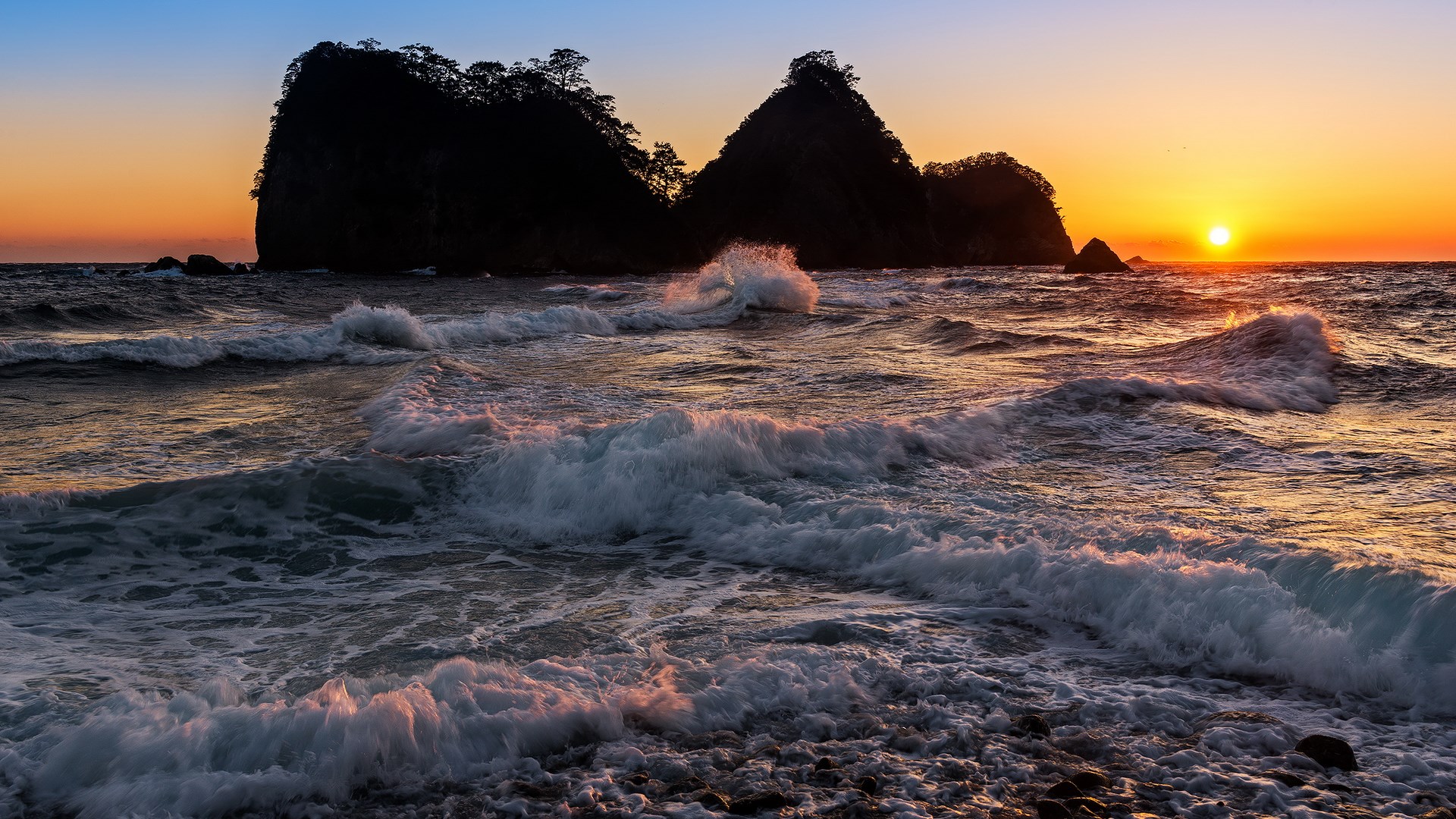 Sunset over rocky islands and ocean waves HD Wallpaper