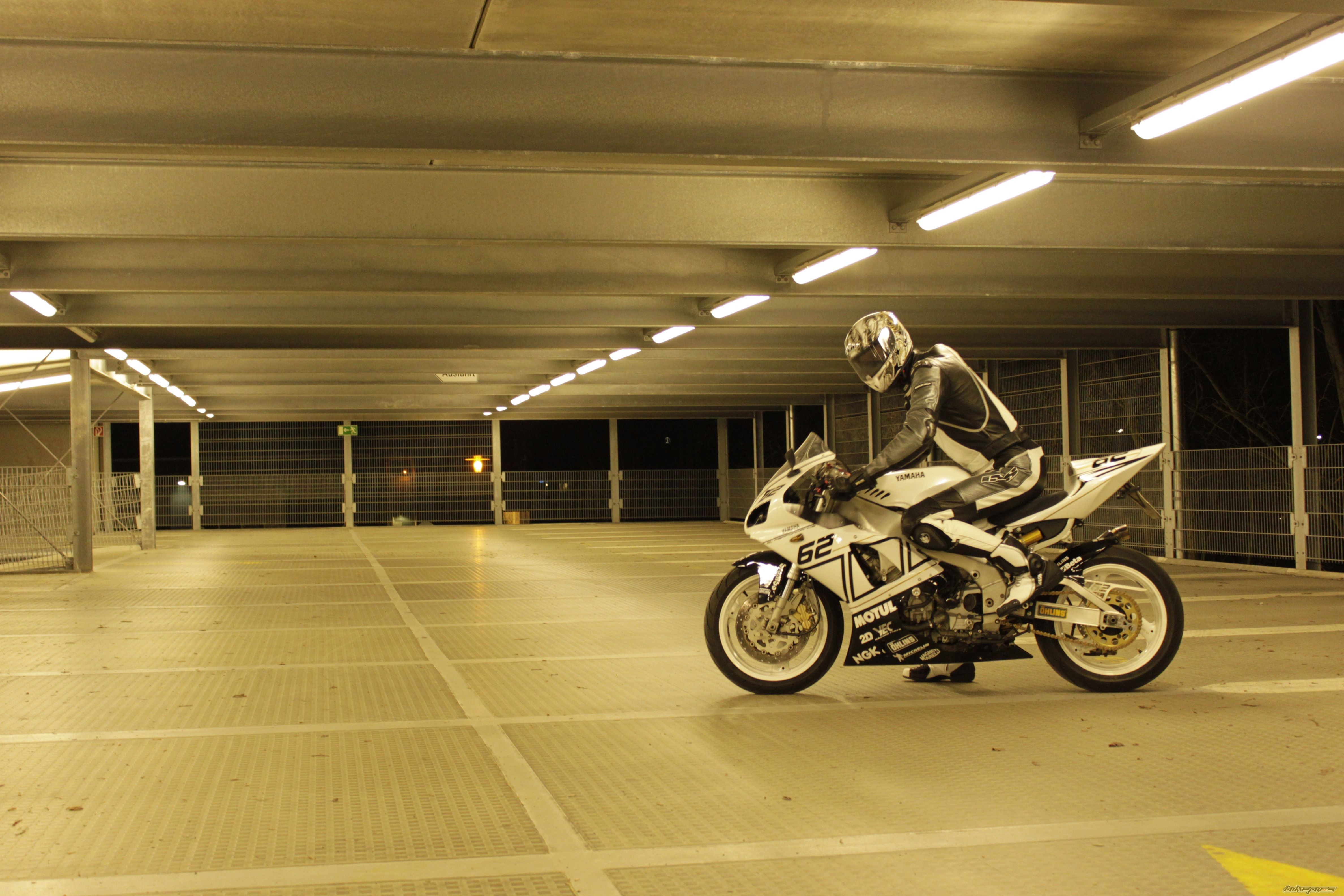 Motorcyclist on a Yamaha motorcycle in a parking garage HD Wallpaper
