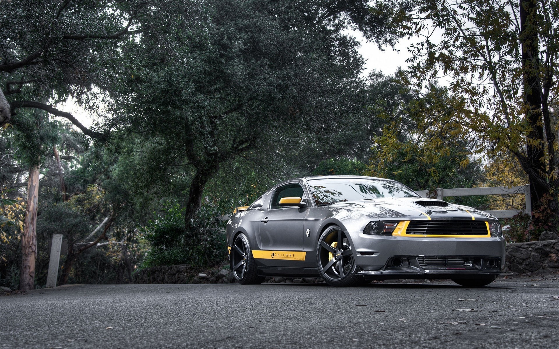 Gray Ford Mustang with yellow accents parked on a road HD Wallpaper