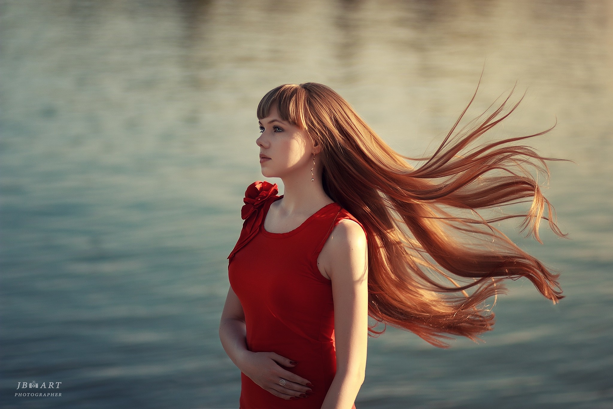 Woman with long red hair in a red dress by the water HD Wallpaper