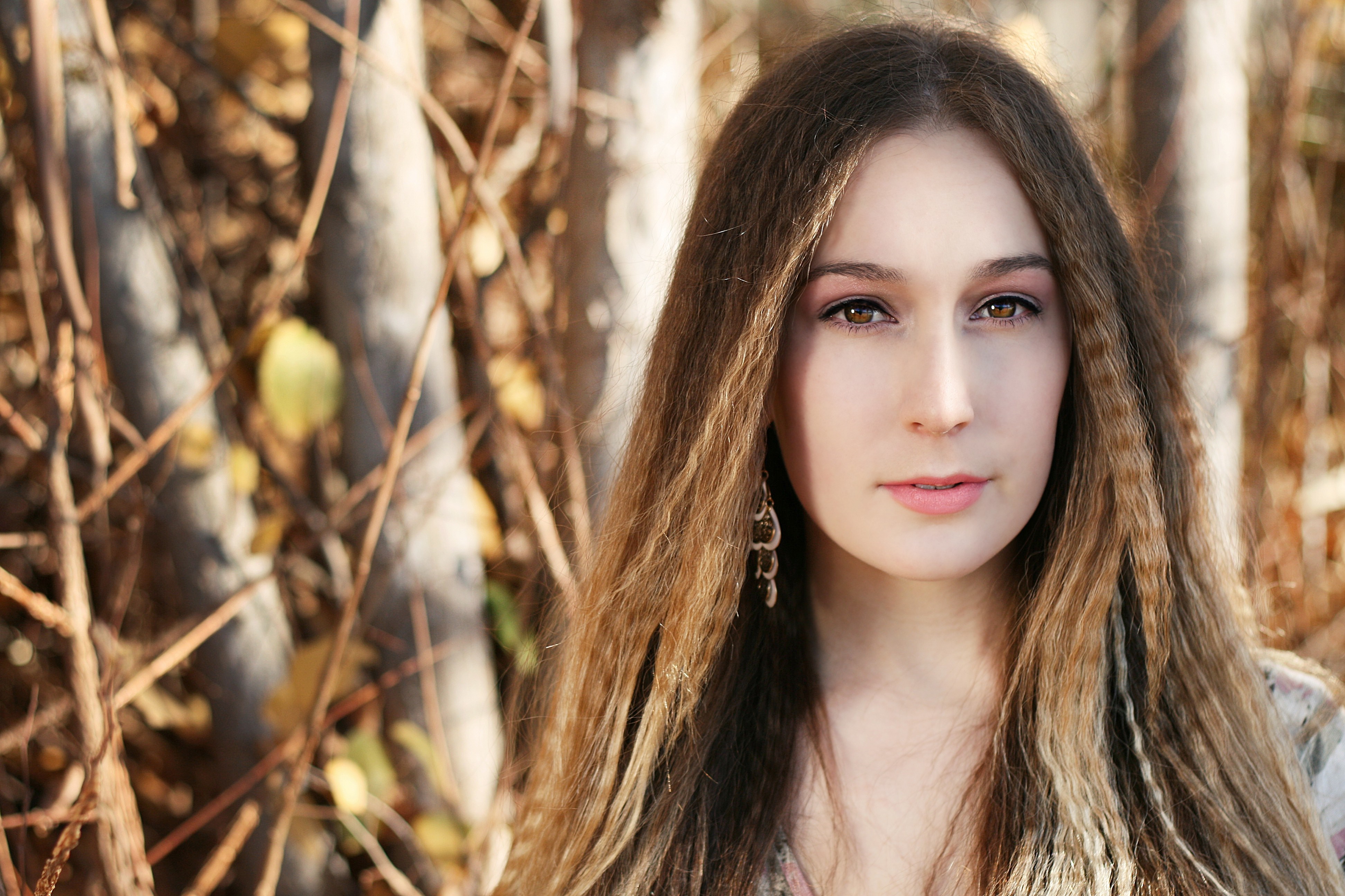 Woman with long brown hair and earrings HD Wallpaper