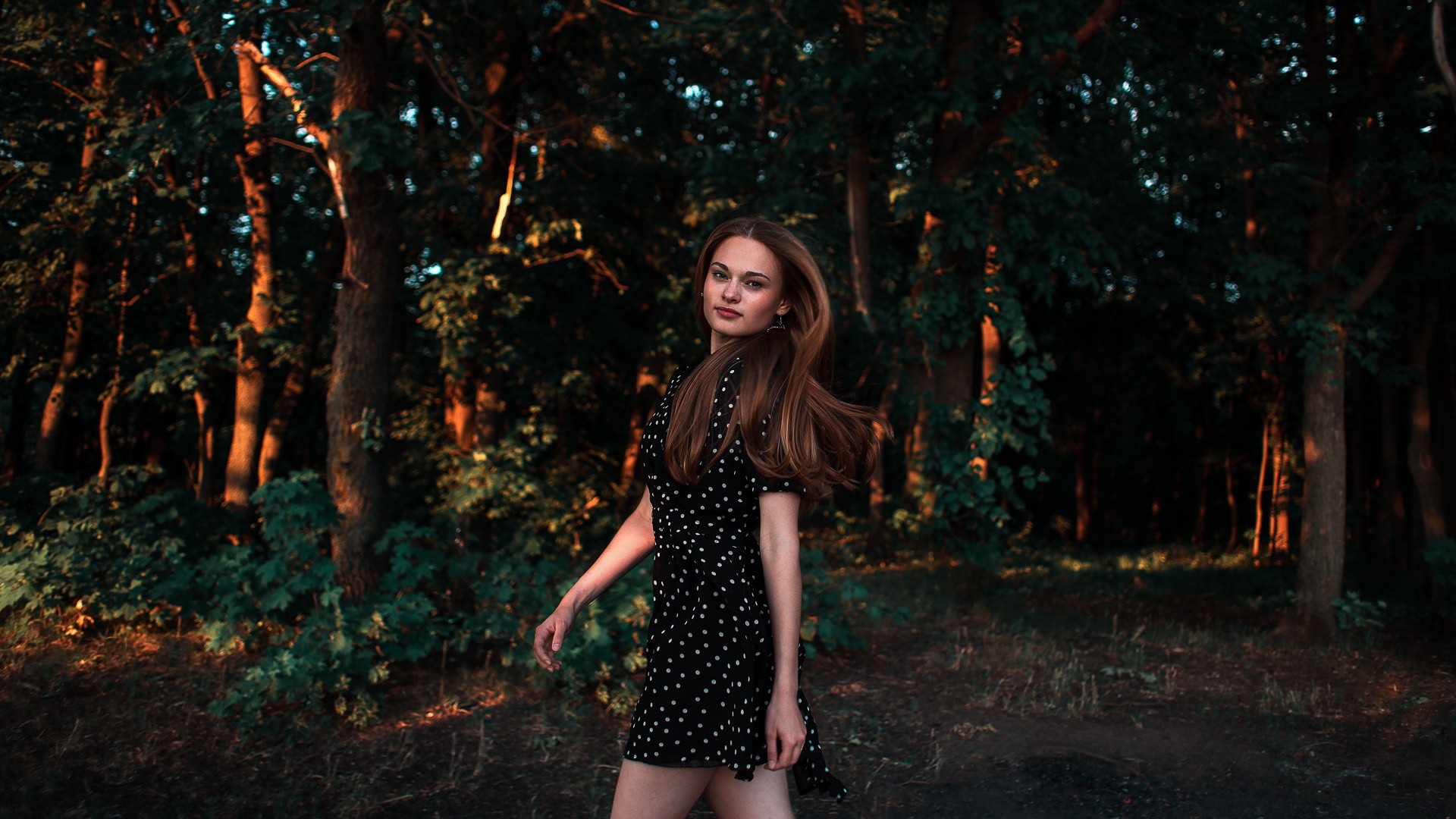 Woman in polka dot dress in forest at sunset HD Wallpaper