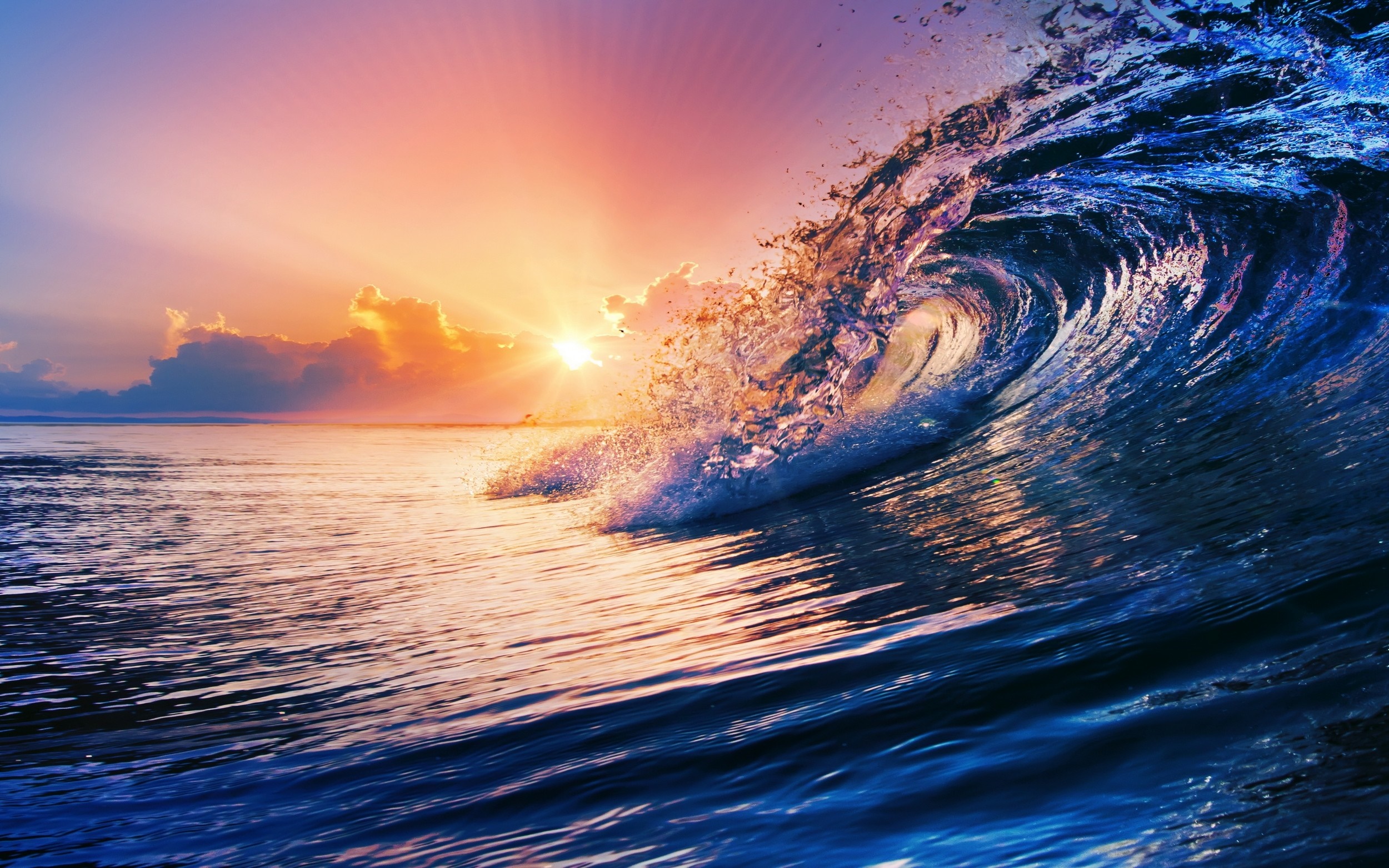 Ocean wave crashing at sunset with colorful sky HD Wallpaper