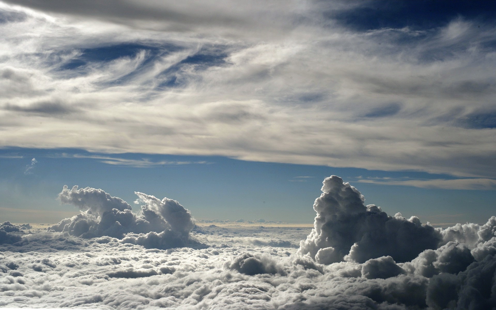 Above the clouds with dramatic cloud formations HD Wallpaper