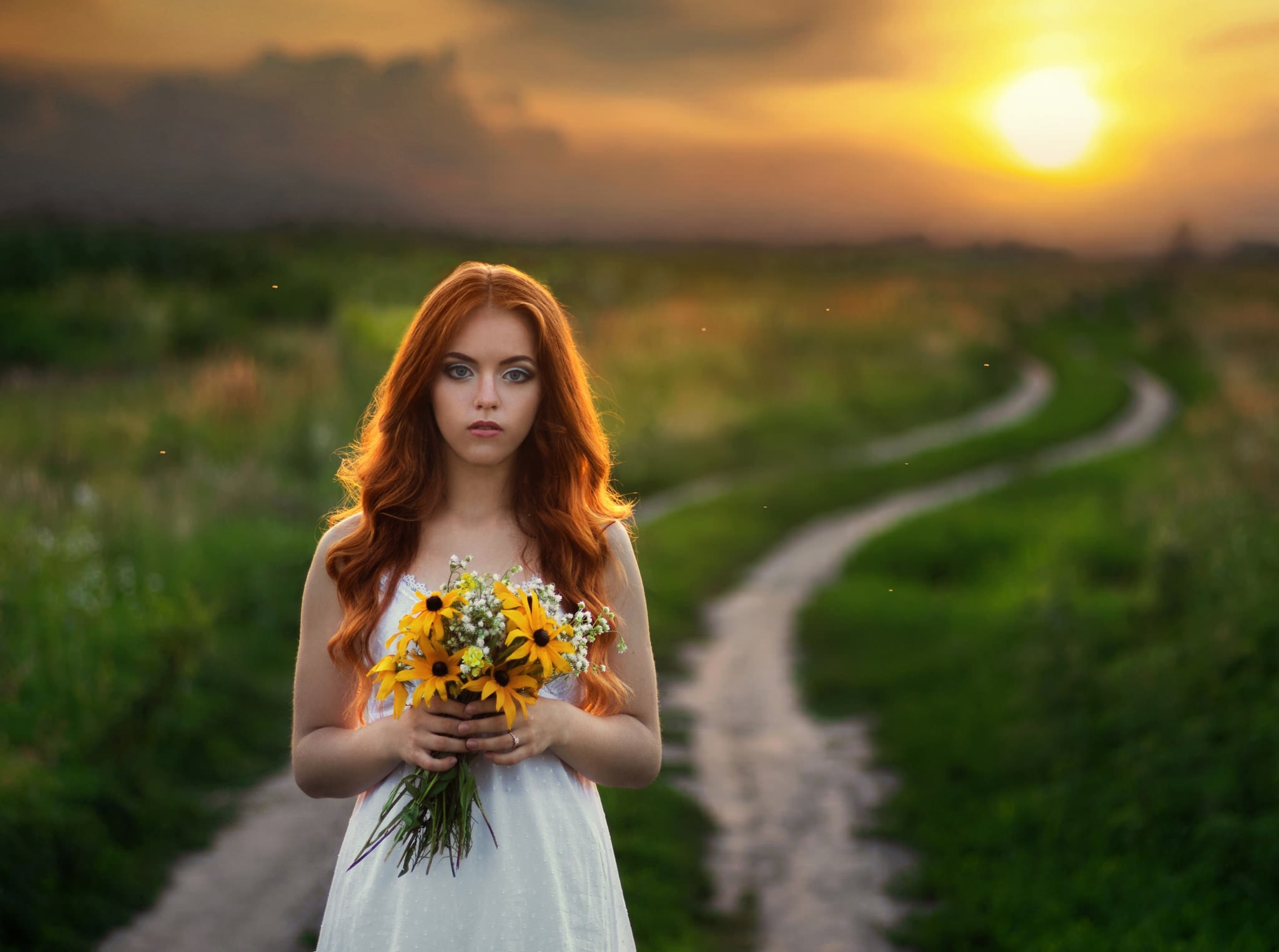 Woman with red hair holding flowers at sunset HD Wallpaper