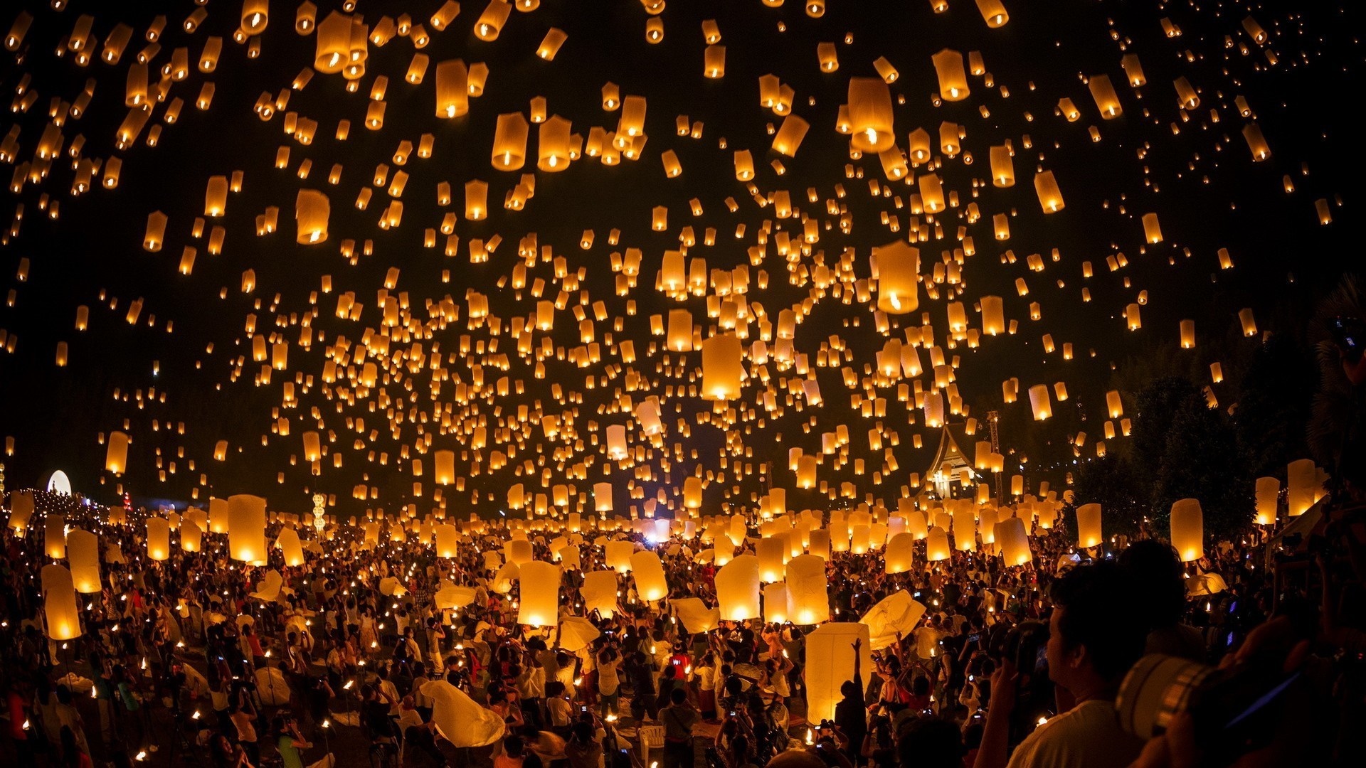 Thousands of lanterns released by a crowd at night HD Wallpaper