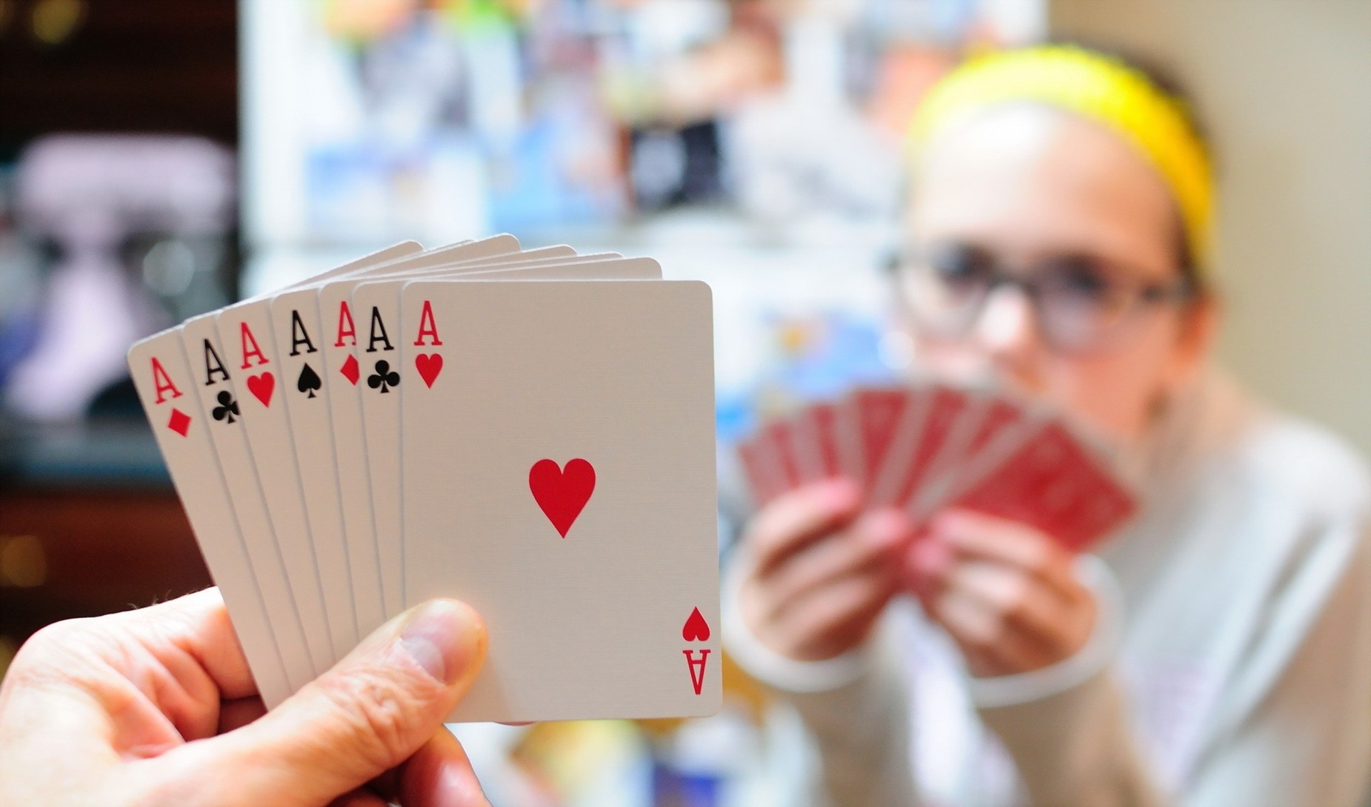 Hand holding multiple aces playing cards HD Wallpaper