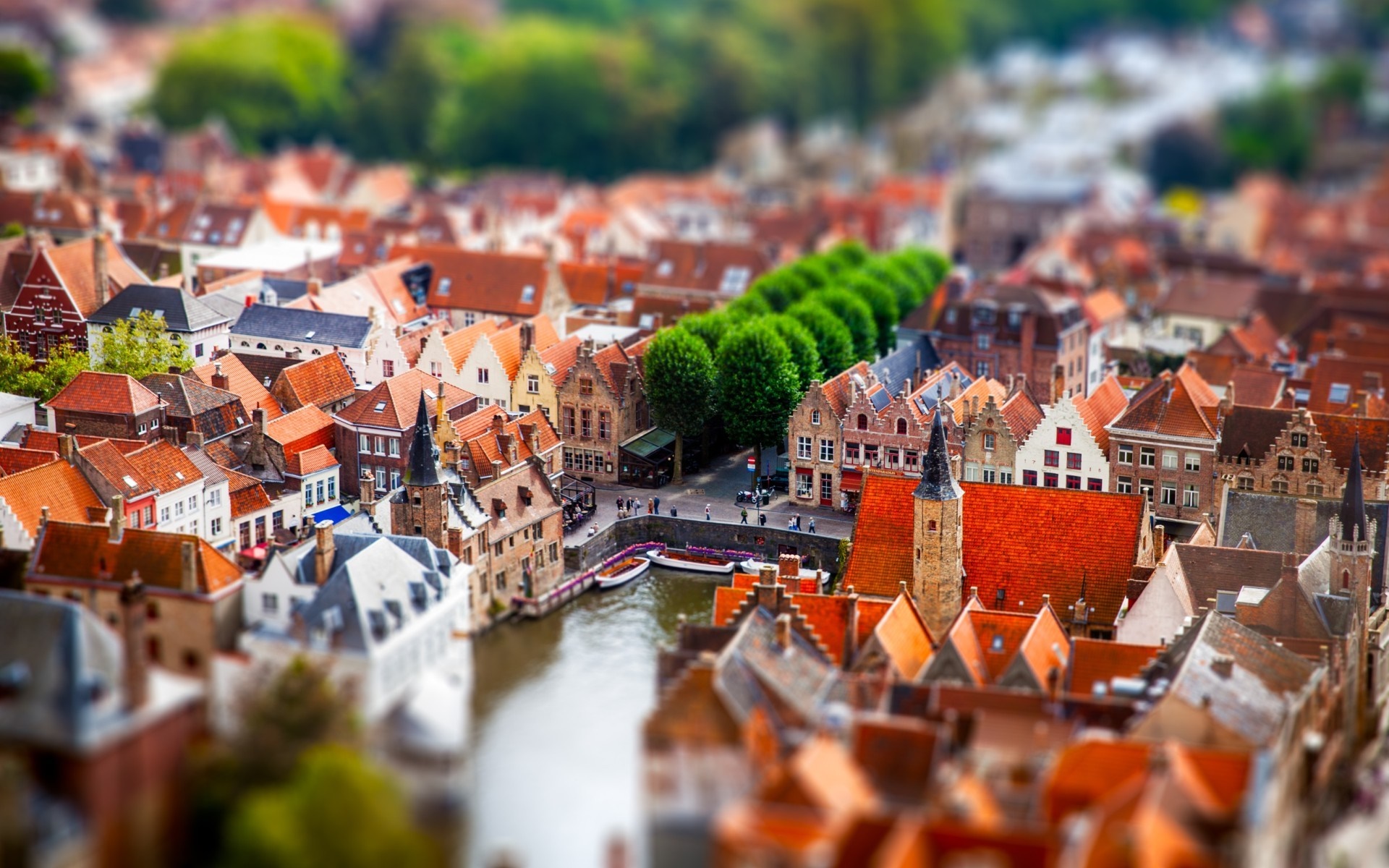 Tilt shift cityscape of Bruges with canal and trees HD Wallpaper