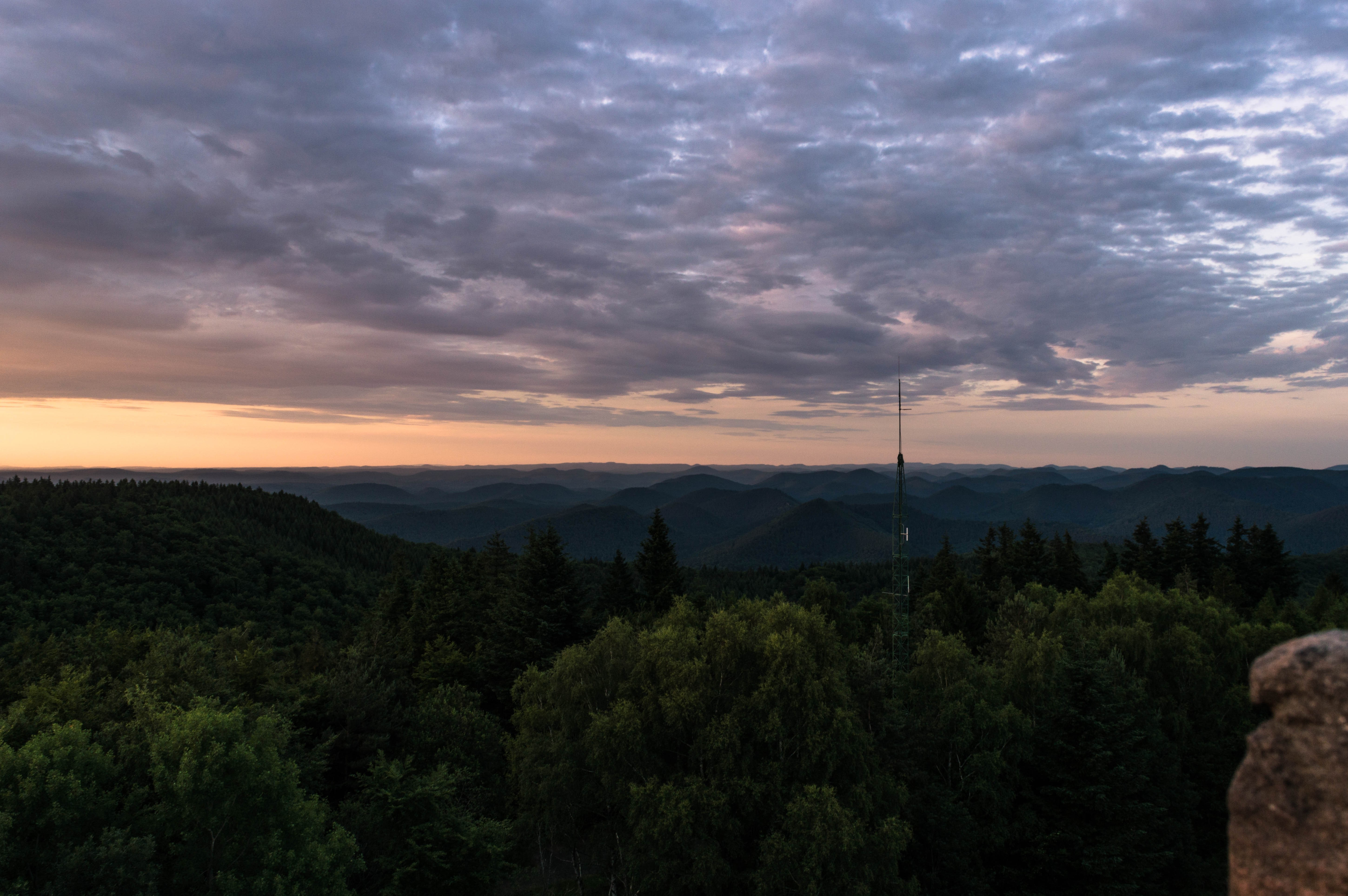 Sunset over rolling hills and forest with radio tower HD Wallpaper