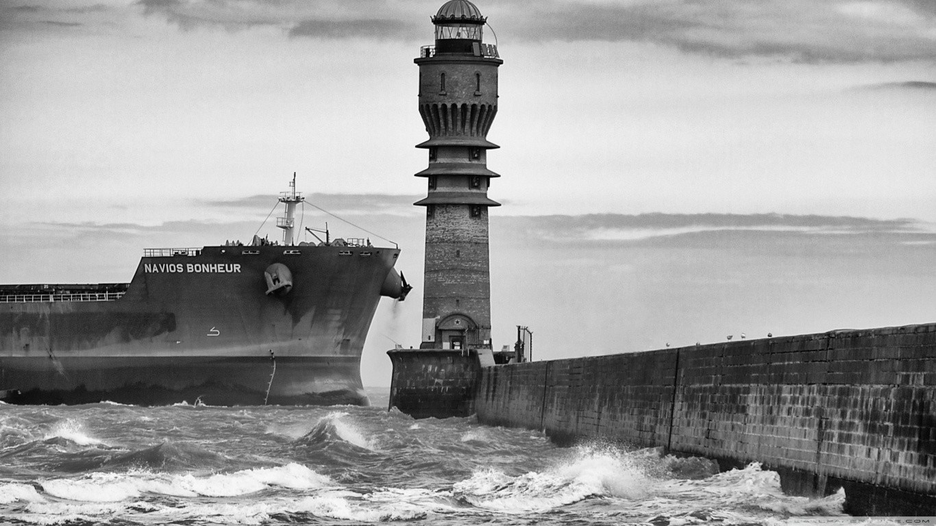 Ship Navios Bonheur passes lighthouse on a pier HD Wallpaper