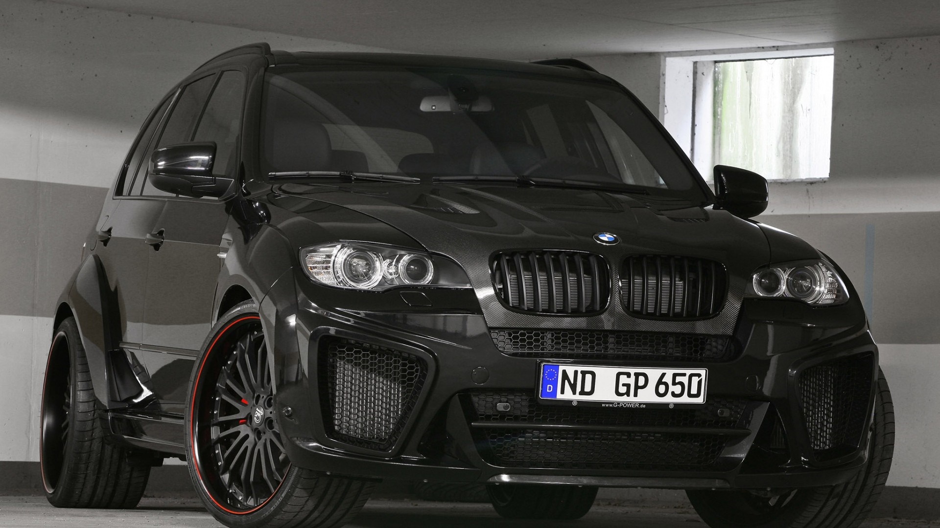 Black BMW X6 with custom rims parked indoors HD Wallpaper