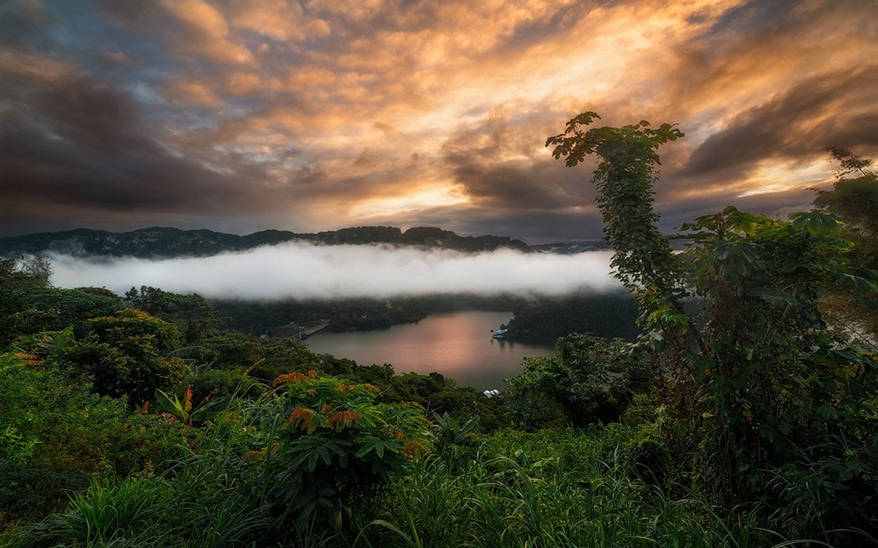 Misty lake and mountains at sunrise with dramatic clouds HD Wallpaper