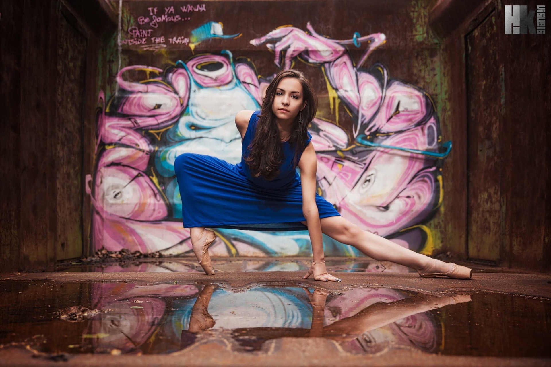 Ballerina in blue dress poses in front of graffiti HD Wallpaper