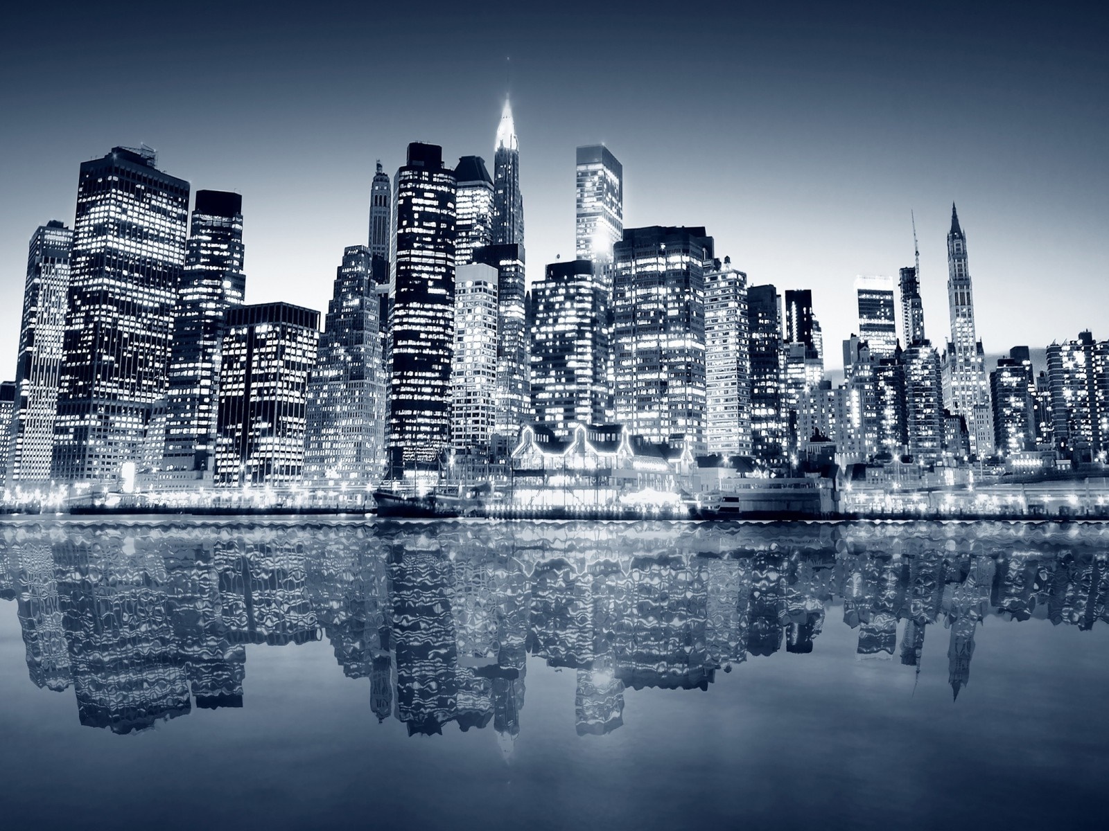 Monochrome cityscape of New York City skyline at night with reflections HD Wallpaper