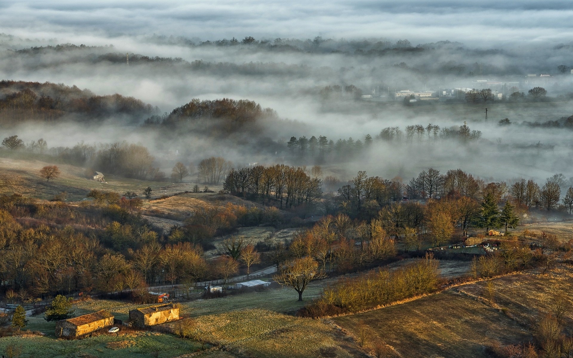 Misty valley with trees and farmhouses in autumn HD Wallpaper
