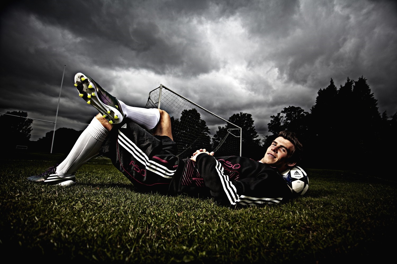 Gareth Bale lying on a football field HD Wallpaper