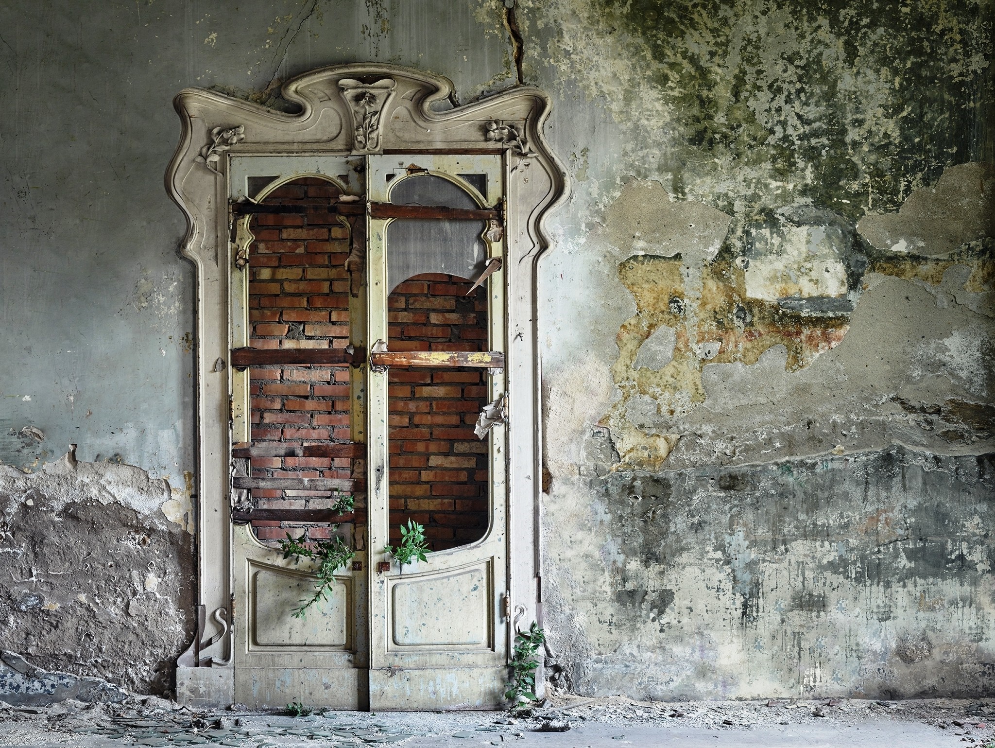 Abandoned doorway with bricked-up windows and decaying wall HD Wallpaper