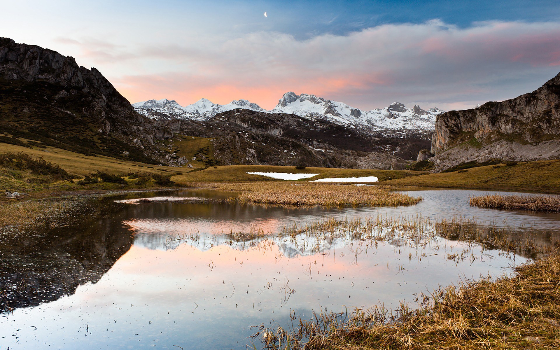 Mountain lake reflecting snow-capped peaks at sunset HD Wallpaper