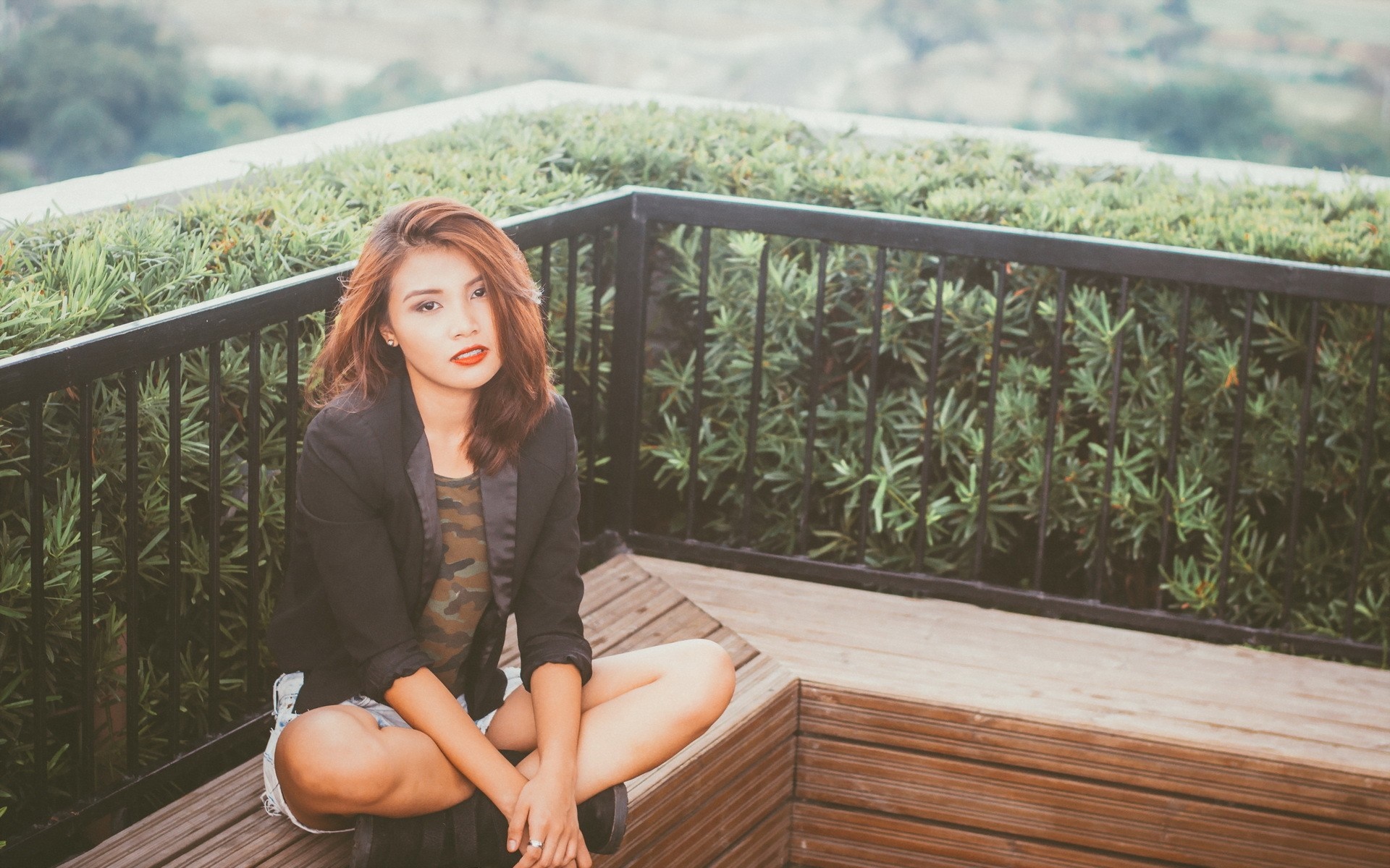 Woman with dyed hair sitting on a wooden deck HD Wallpaper