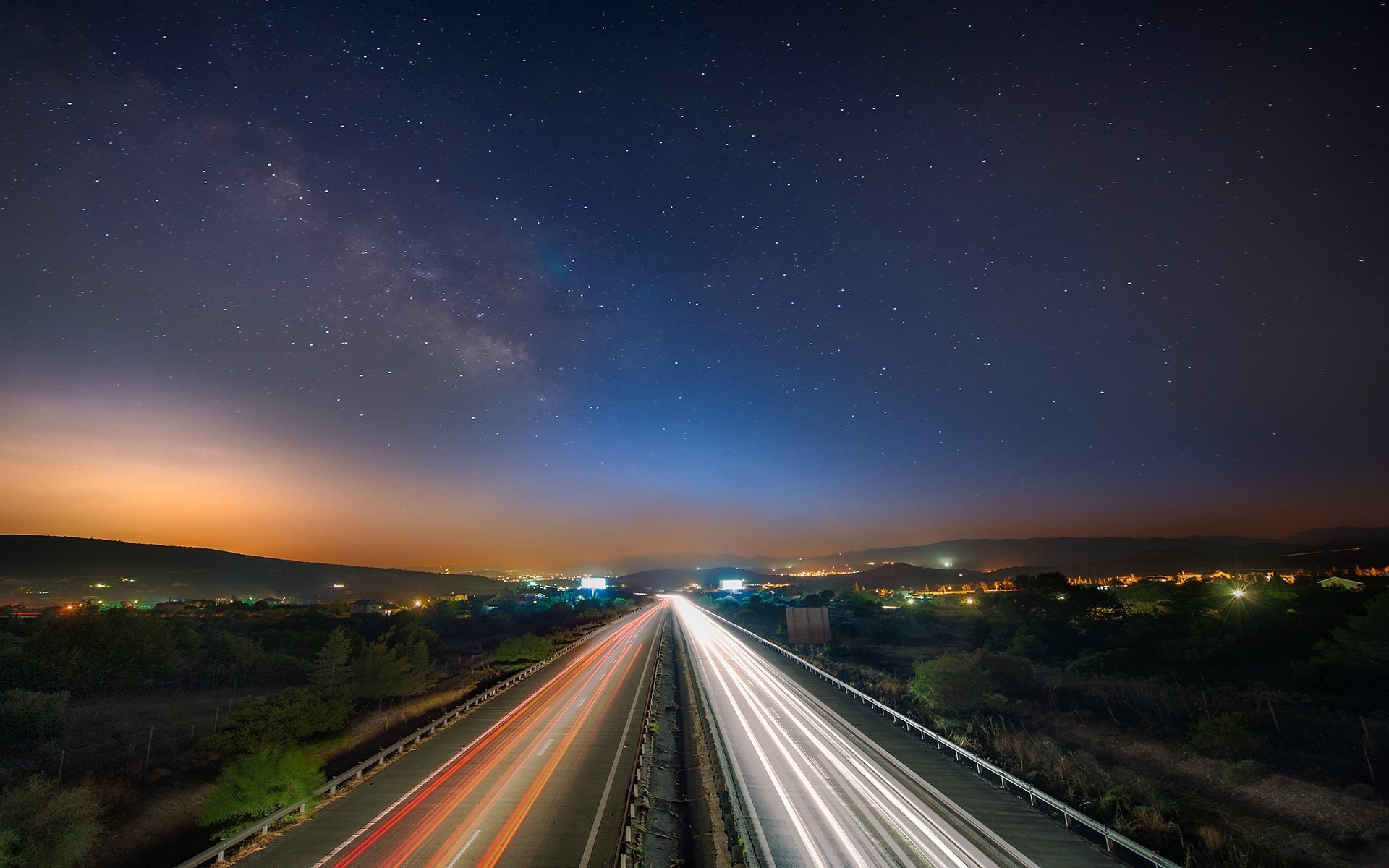 Highway at night with Milky Way and light trails HD Wallpaper
