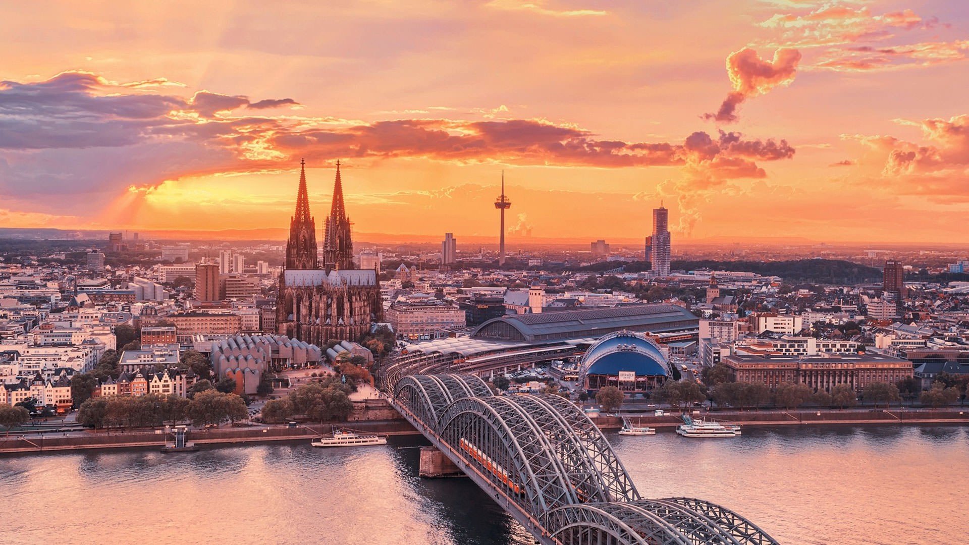 Cologne Cathedral and Hohenzollern Bridge at sunset HD Wallpaper