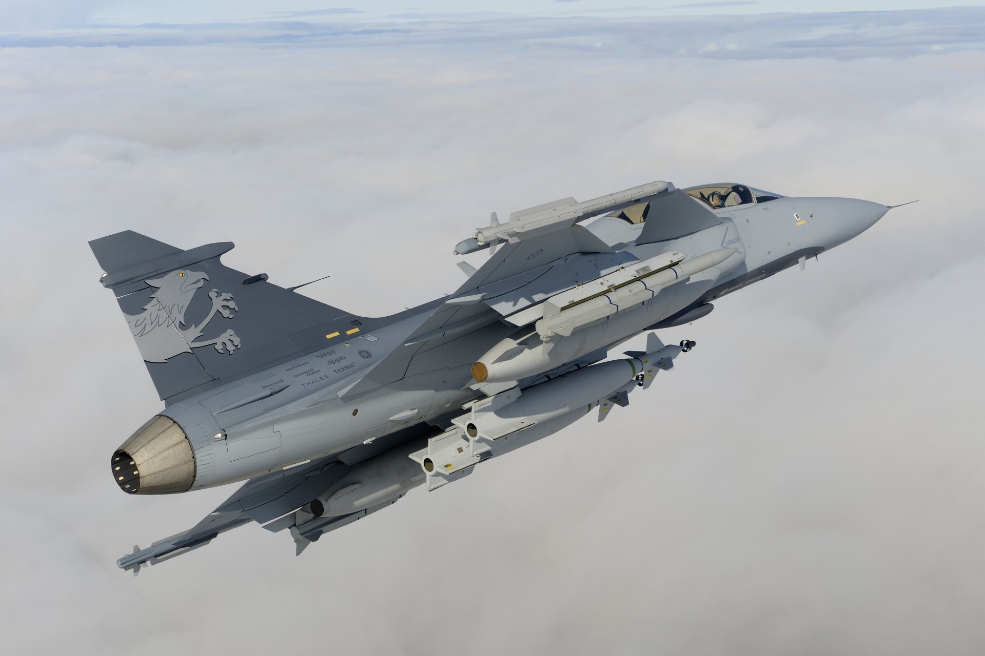 JAS 39 Gripen fighter jet flying above clouds HD Wallpaper