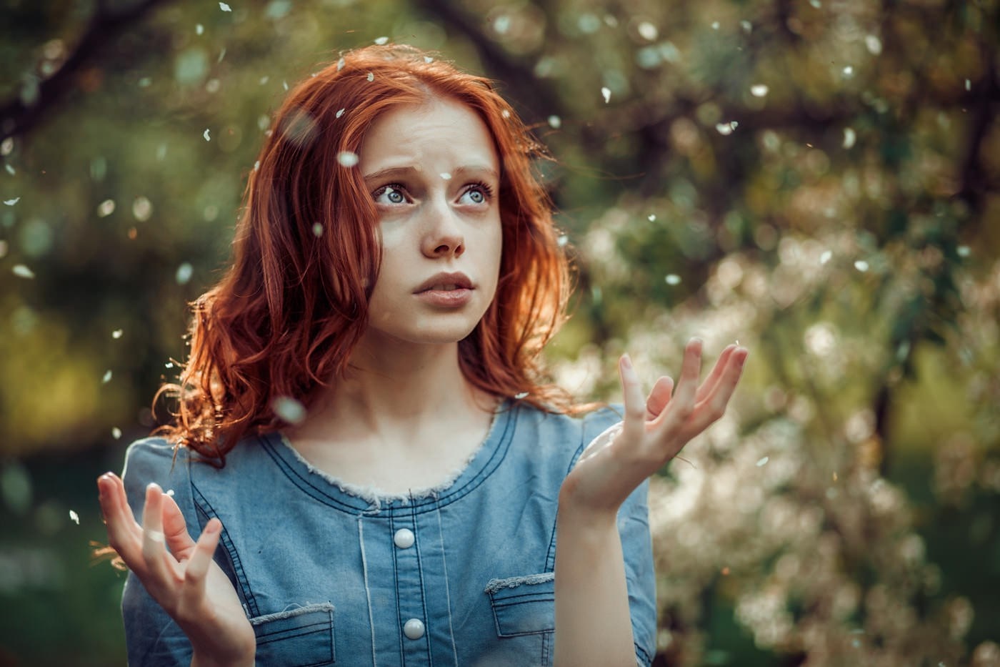 Redhead girl with petals falling around her HD Wallpaper