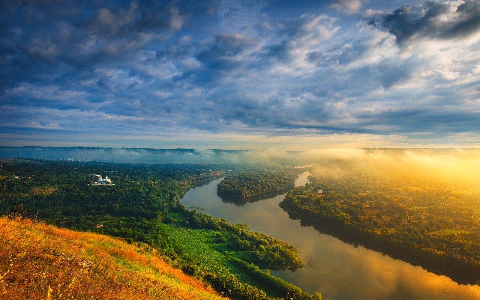 River valley with mist and sunrise over hills HD Wallpaper