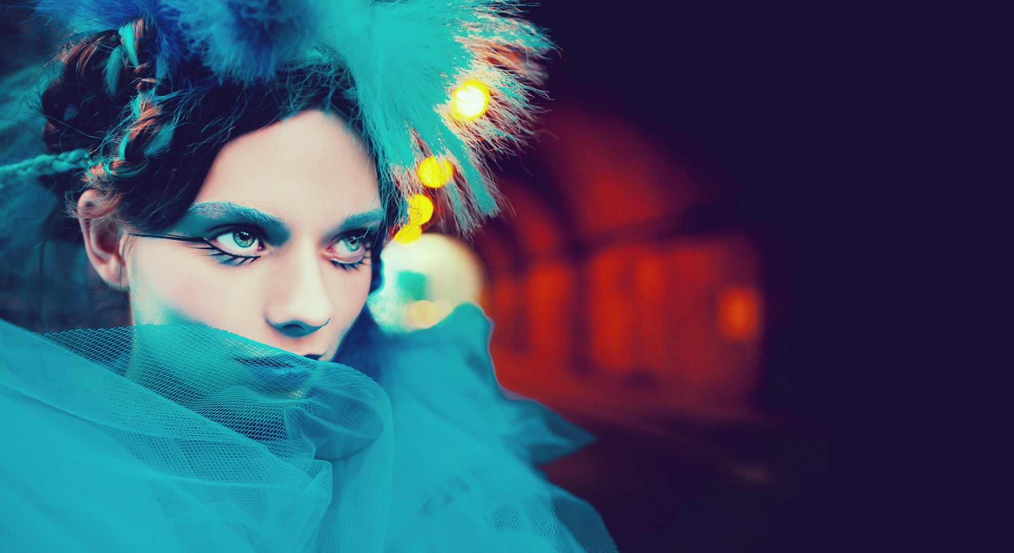 Woman with blue makeup and feathers in hair HD Wallpaper