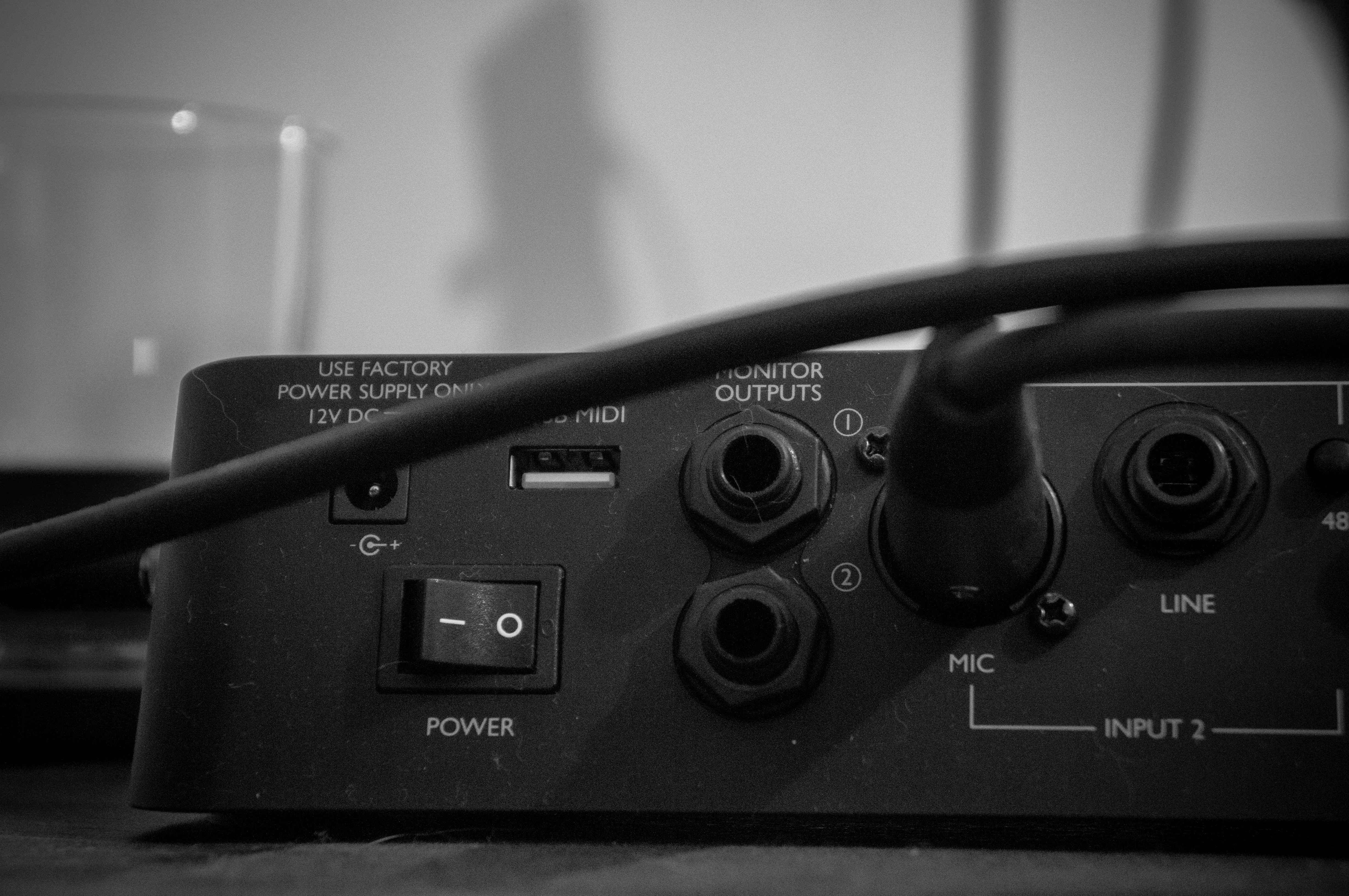 Close-up of audio interface rear panel with cables HD Wallpaper