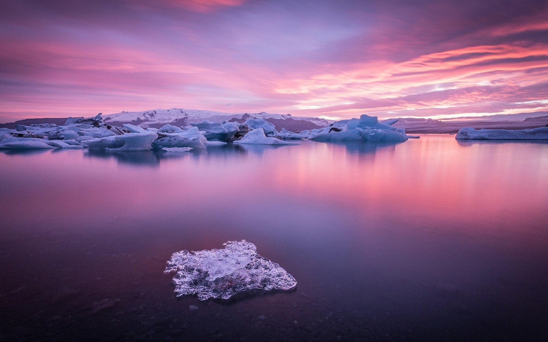 Icebergs floating in a lake at sunset HD Wallpaper