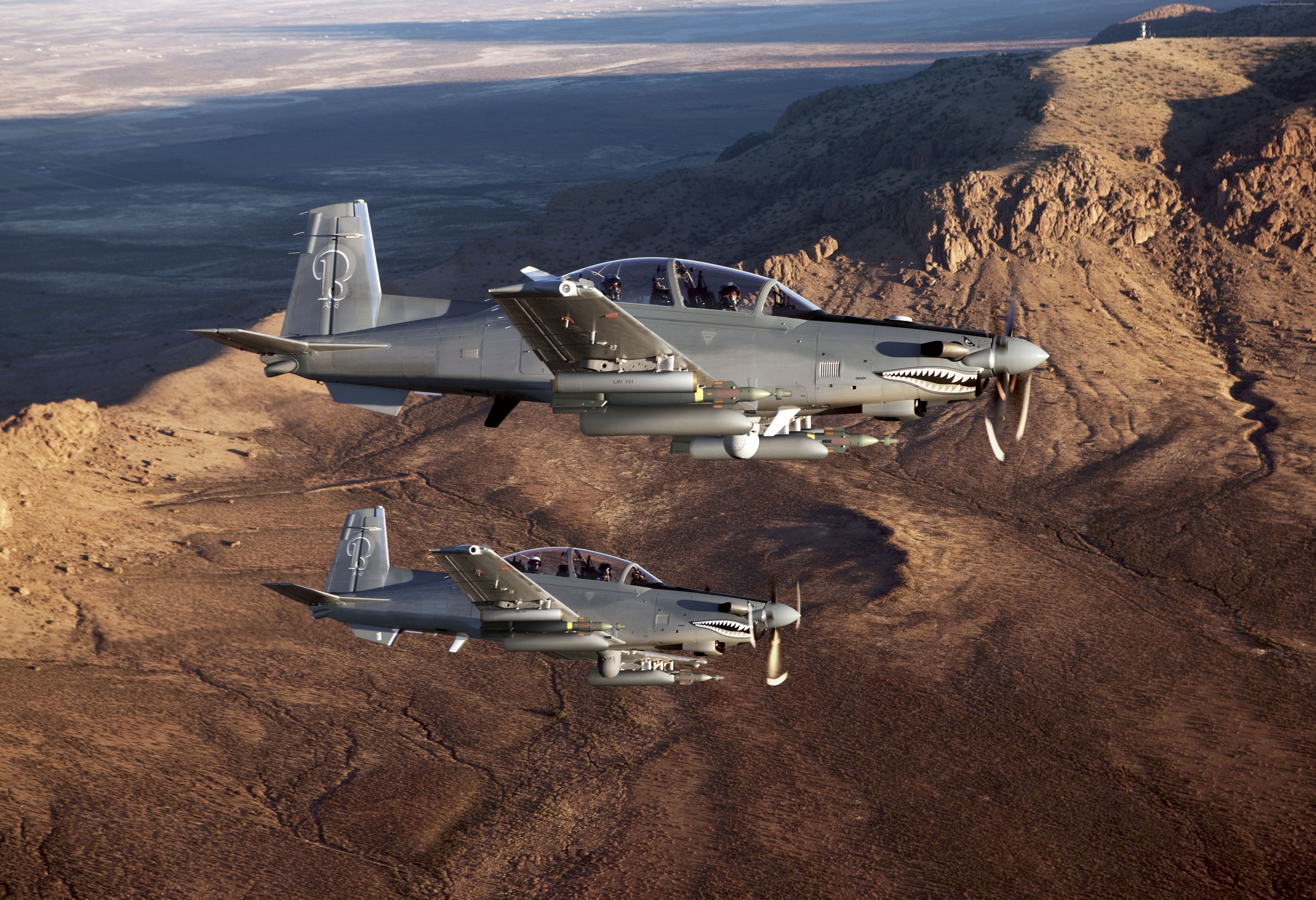 Two Beechcraft AT-6 light attack aircraft in flight HD Wallpaper