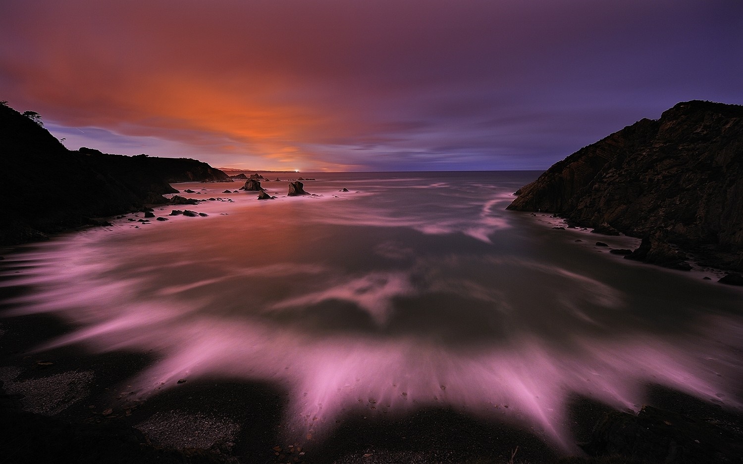 Long exposure of a rocky coast at sunset with colorful clouds HD Wallpaper