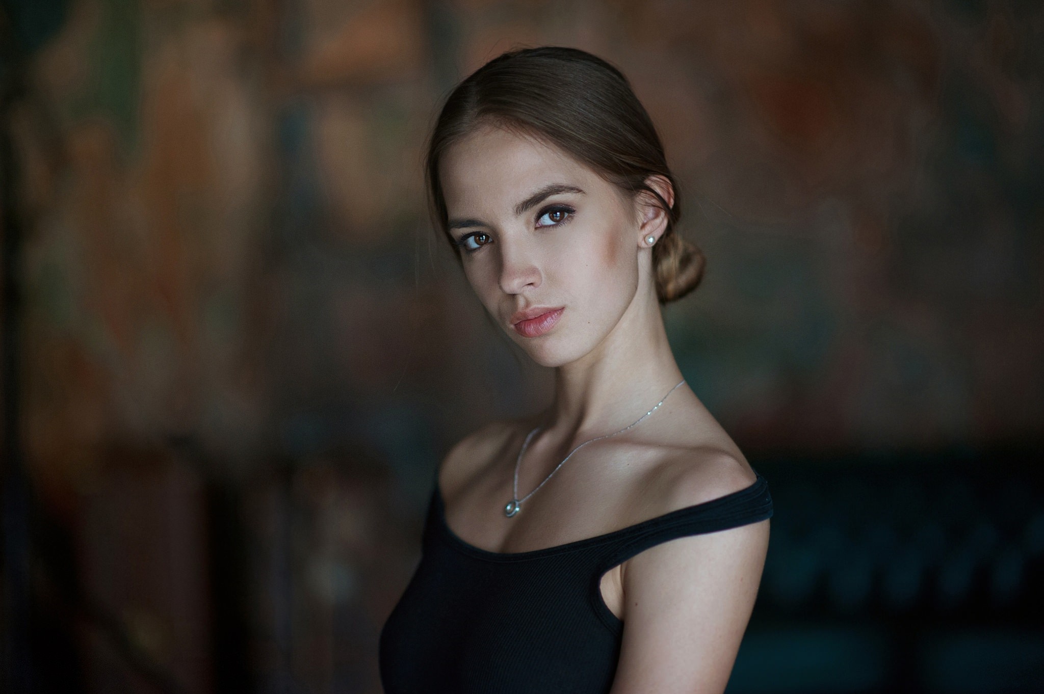 Portrait of a young woman with brown hair tied back HD Wallpaper