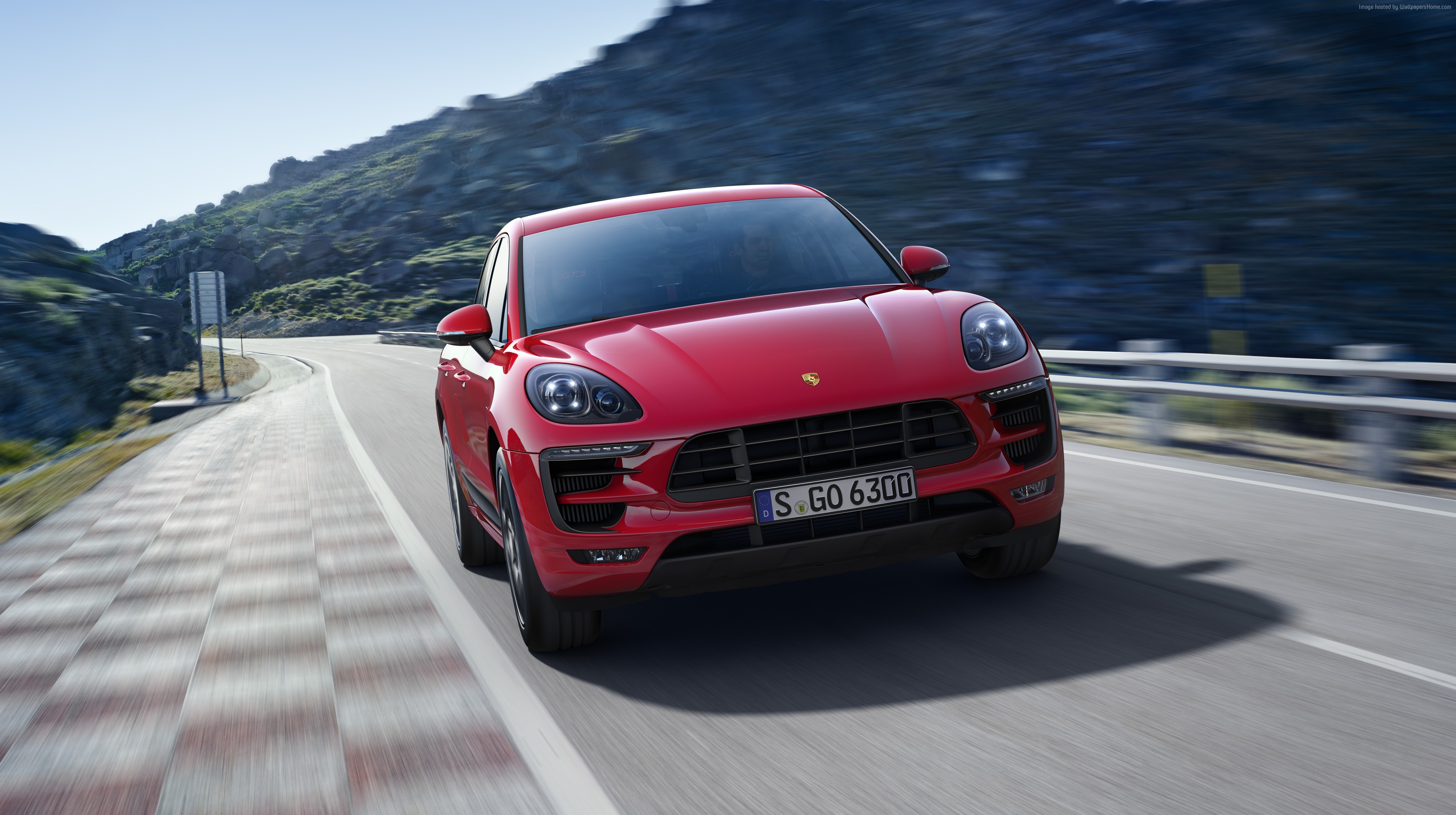 Red Porsche Macan GTS driving on a mountain road HD Wallpaper
